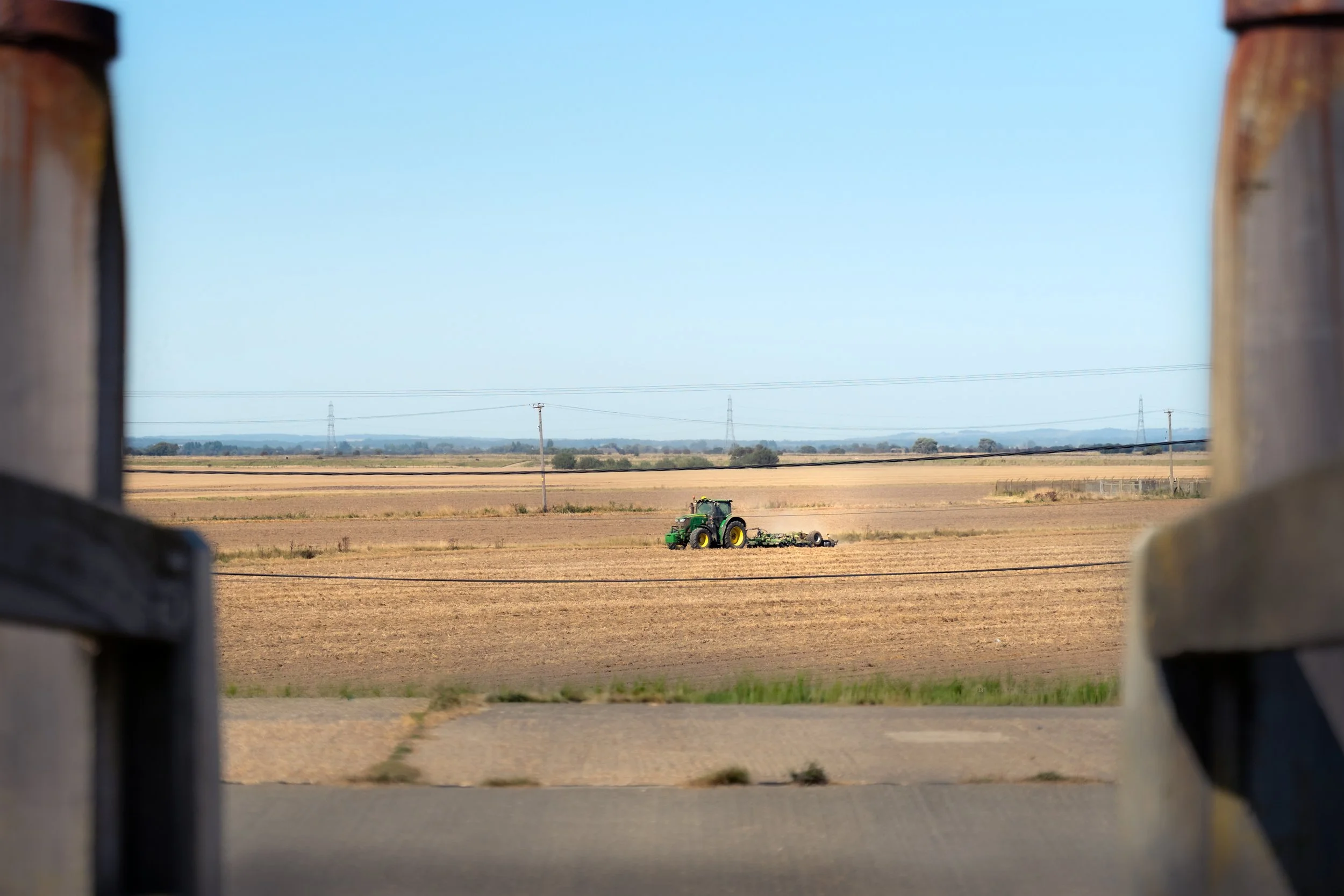 Green Tractor Working on Farmland During Harvest Season - master.jpg