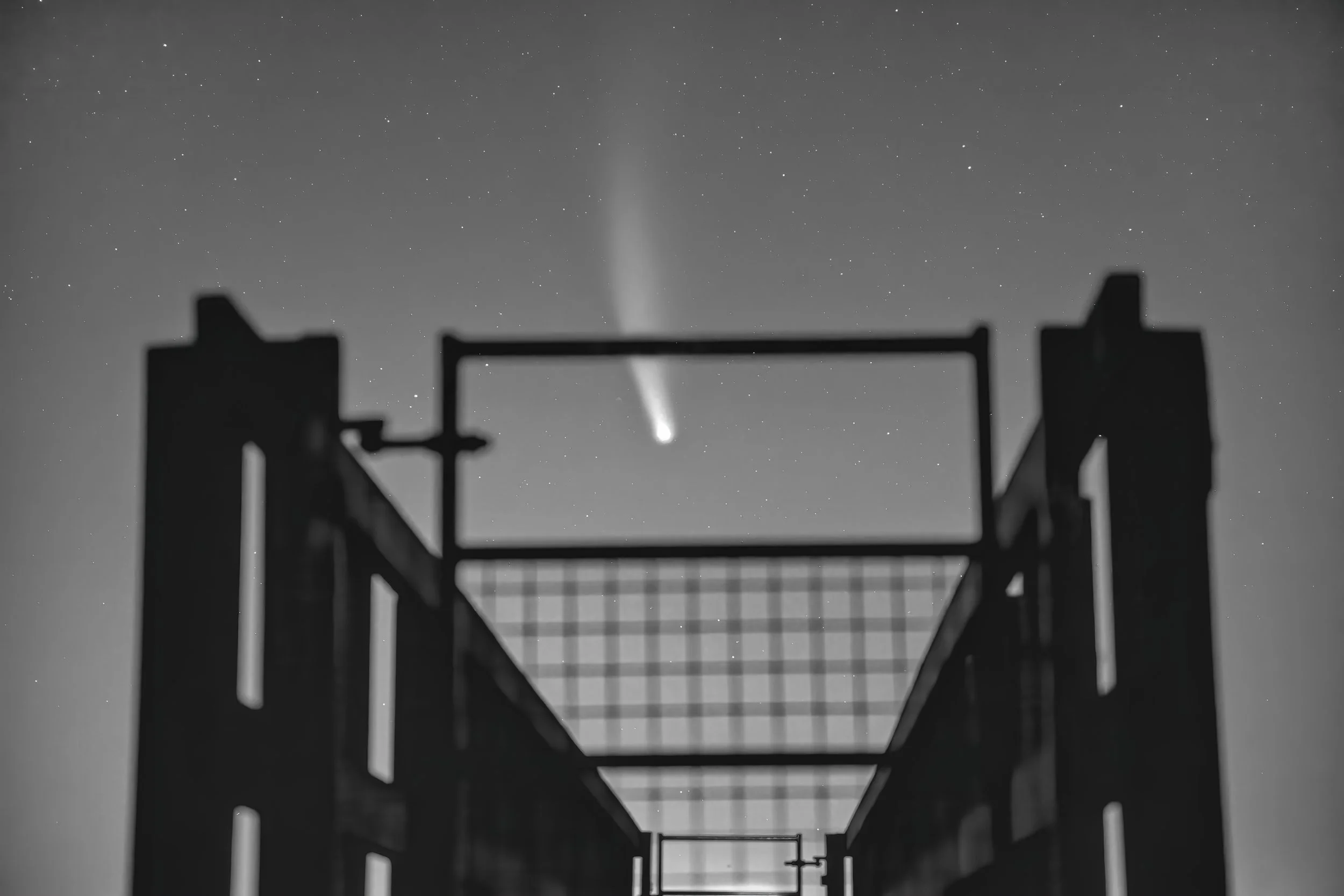 Comet in the Night Sky Framed by Urban Structure.jpg