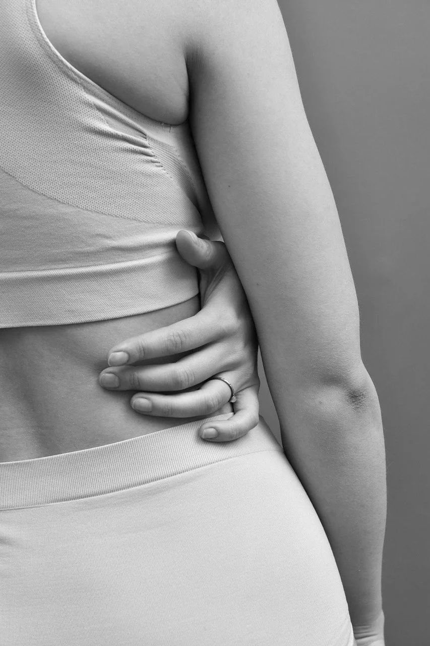 black-and-white-image-of-hand-wrapped-around-body