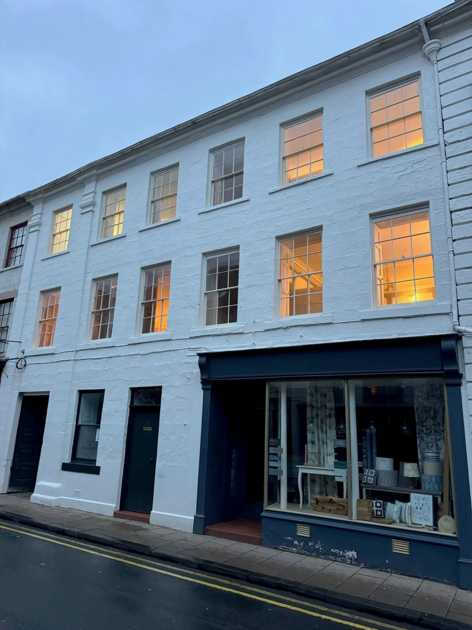 building at dusk with lights on in windows