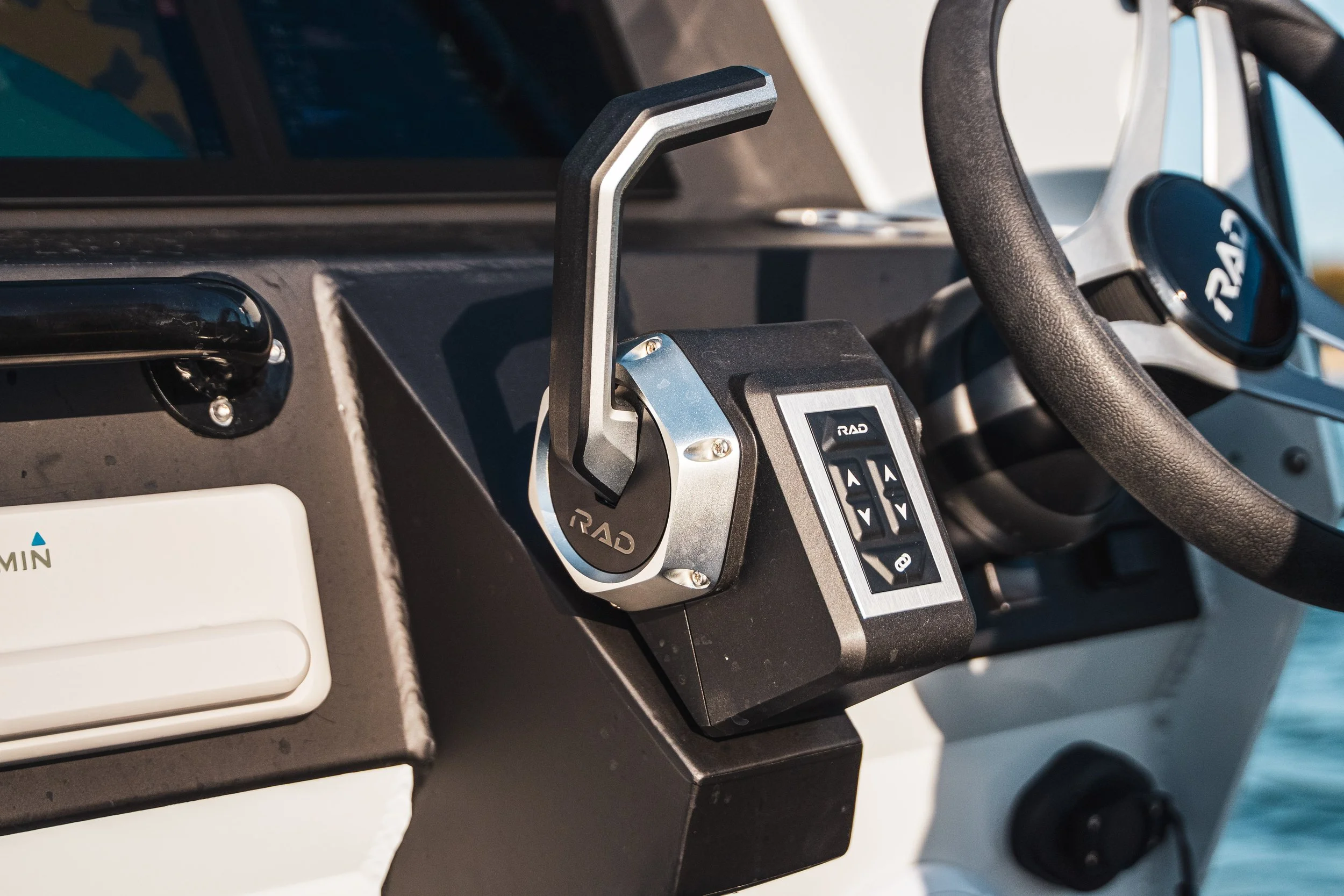Close-up of a steering wheel, a radio control panel, and a mount for a device in a vehicle dashboard.