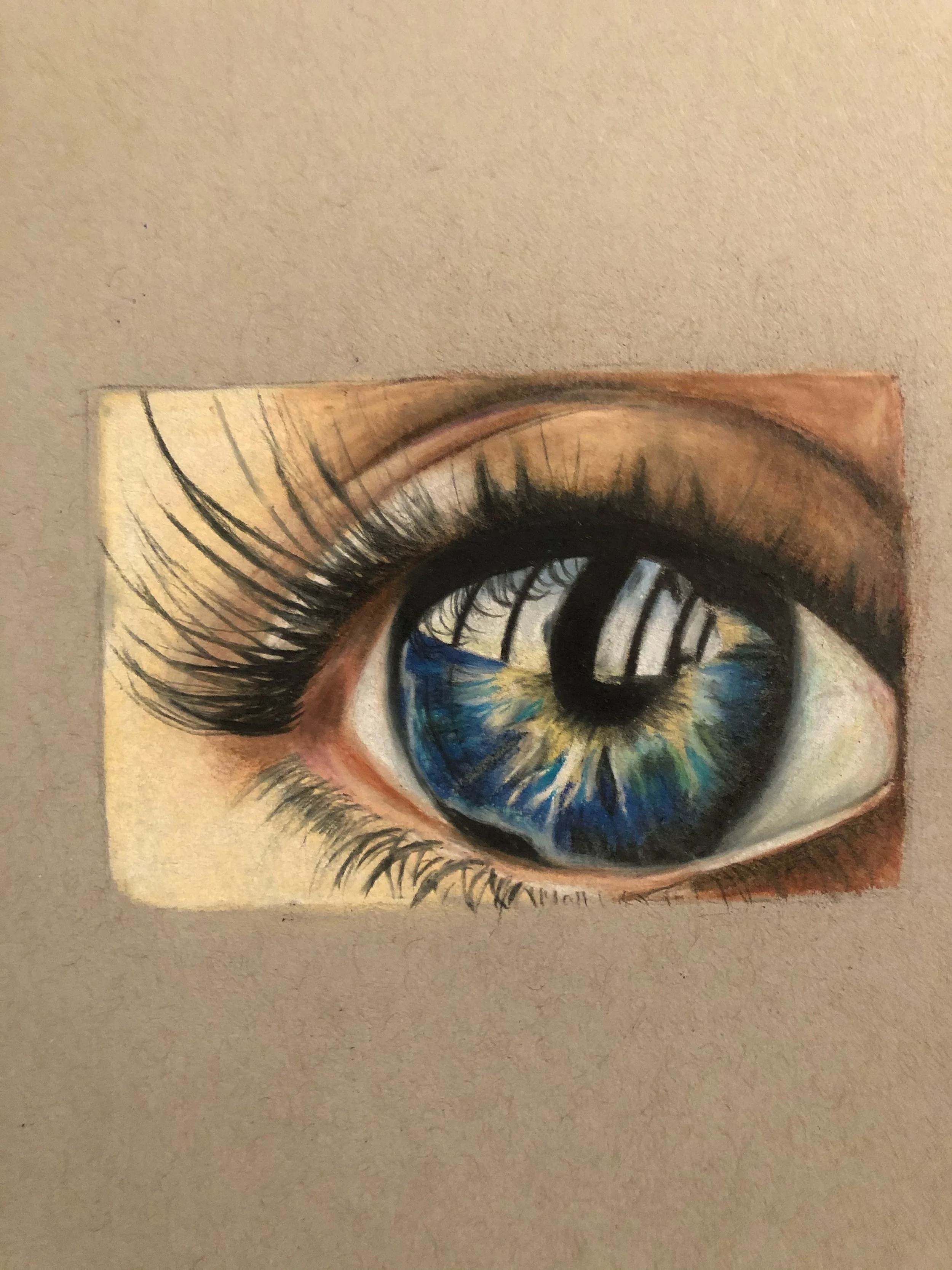 Detailed colored pencil drawing of a realistic human eye, showing blue iris, black pupil, and eyelashes on beige paper.