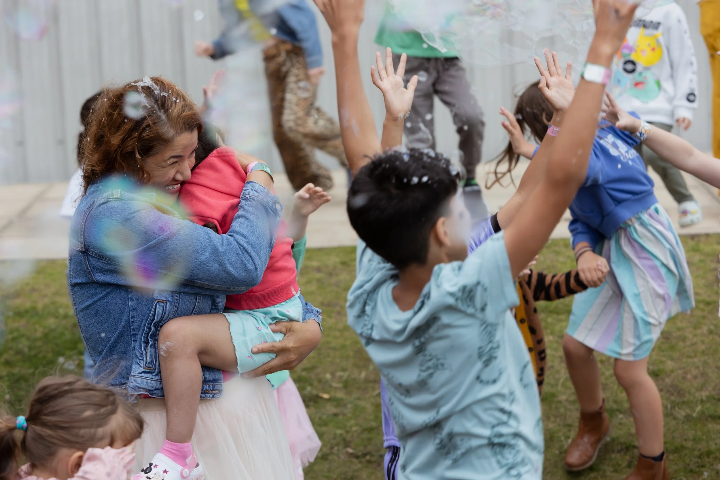 Family playing with bubbles outside