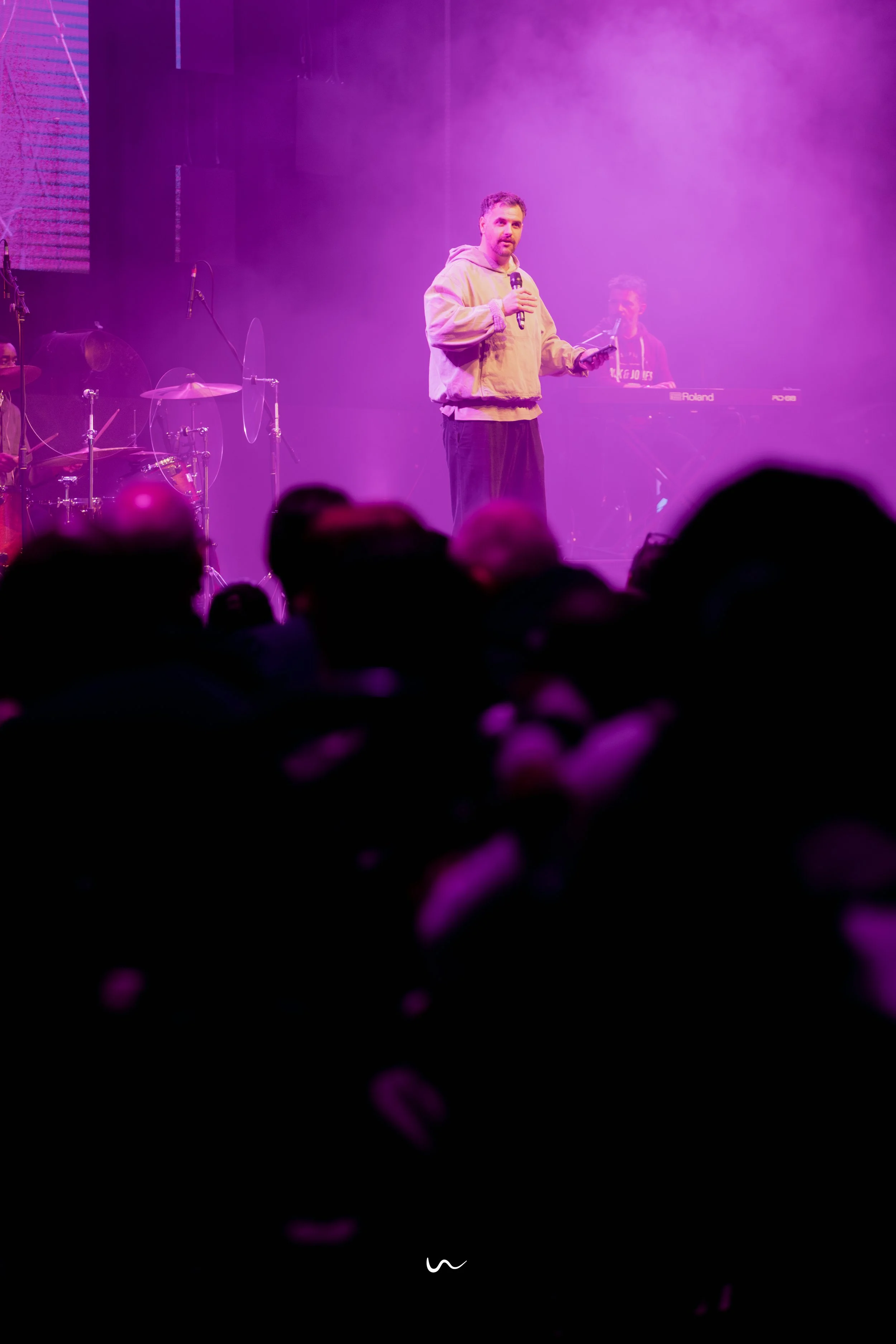 Man on stage speaking to church