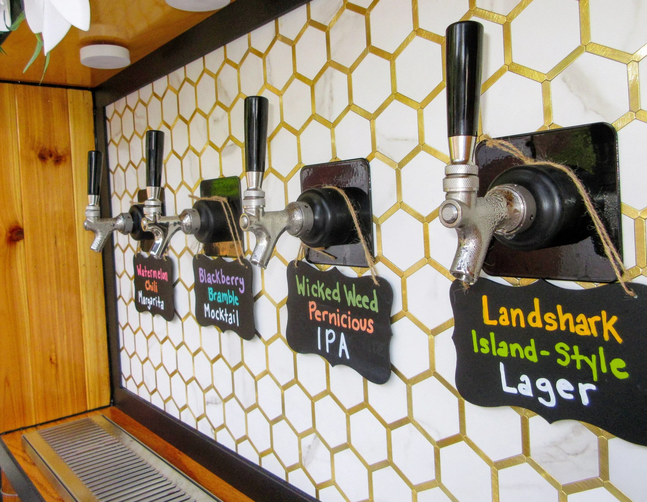 BeesWings Mobile Drinkery Tapcart, up close of the taps, four taps, two beers, one margarita, one mocktail