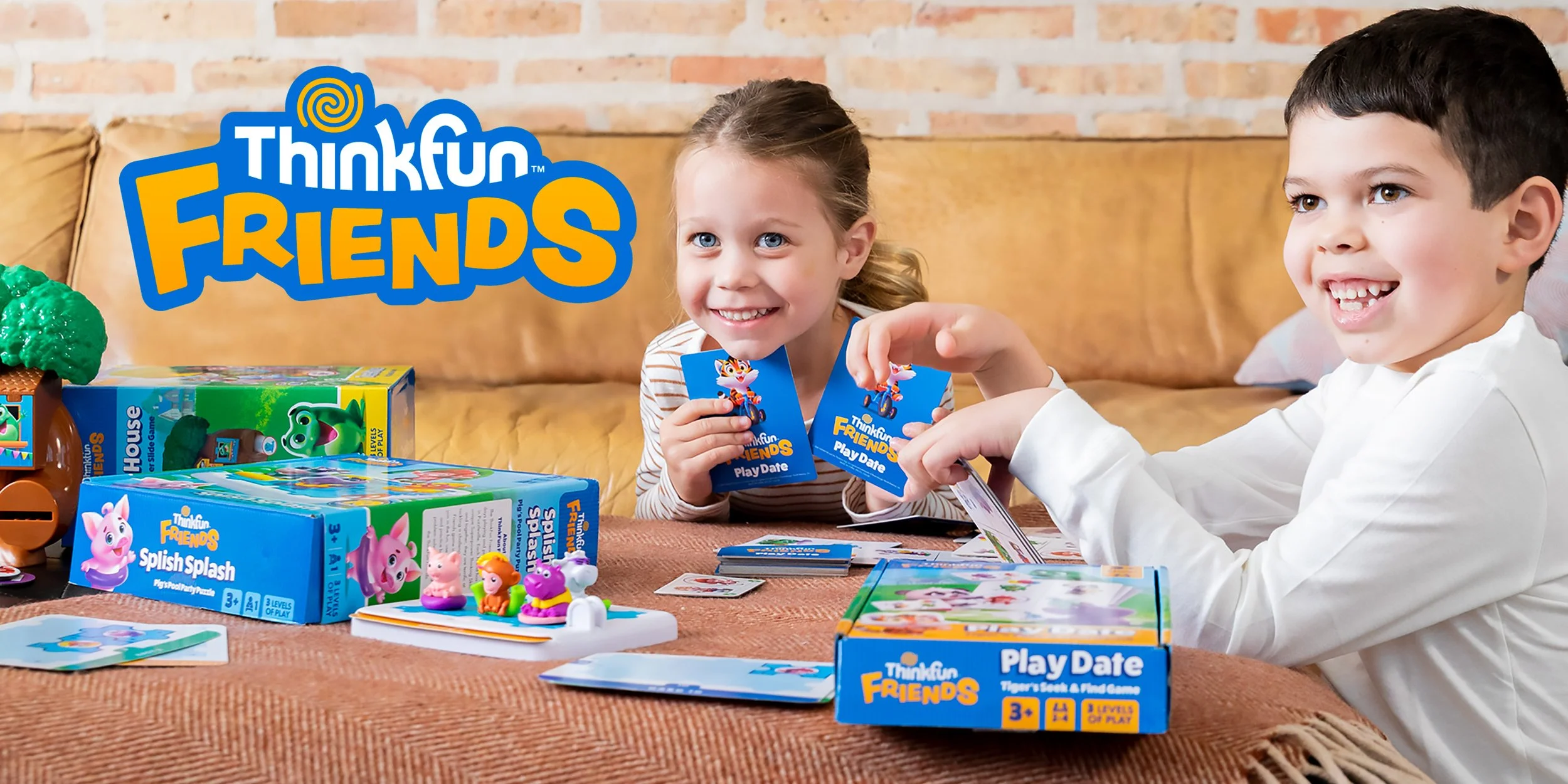 Two children playing the ThinkFun FRIENDS card game at a table with game boxes and figurines in a cozy room with a brick wall background.