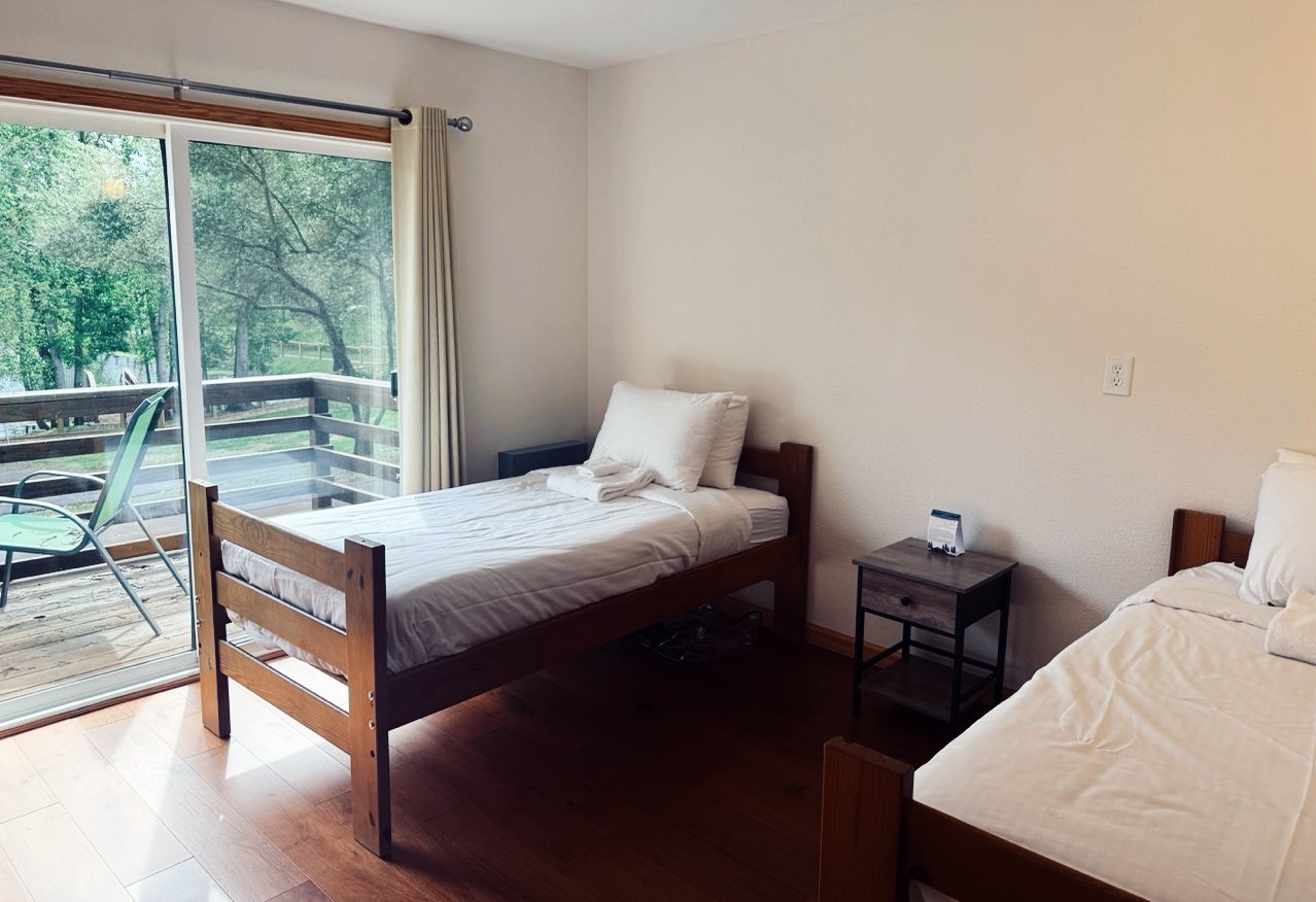 A Twin Room with a balcony at the Lodge at Enchanted Hills.