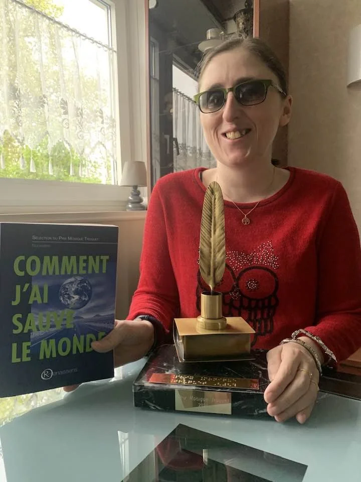 Fayabird tenant le trophée du Prix Monique Truquet 2025 et le recueil "Comment j'ai sauvé le monde"