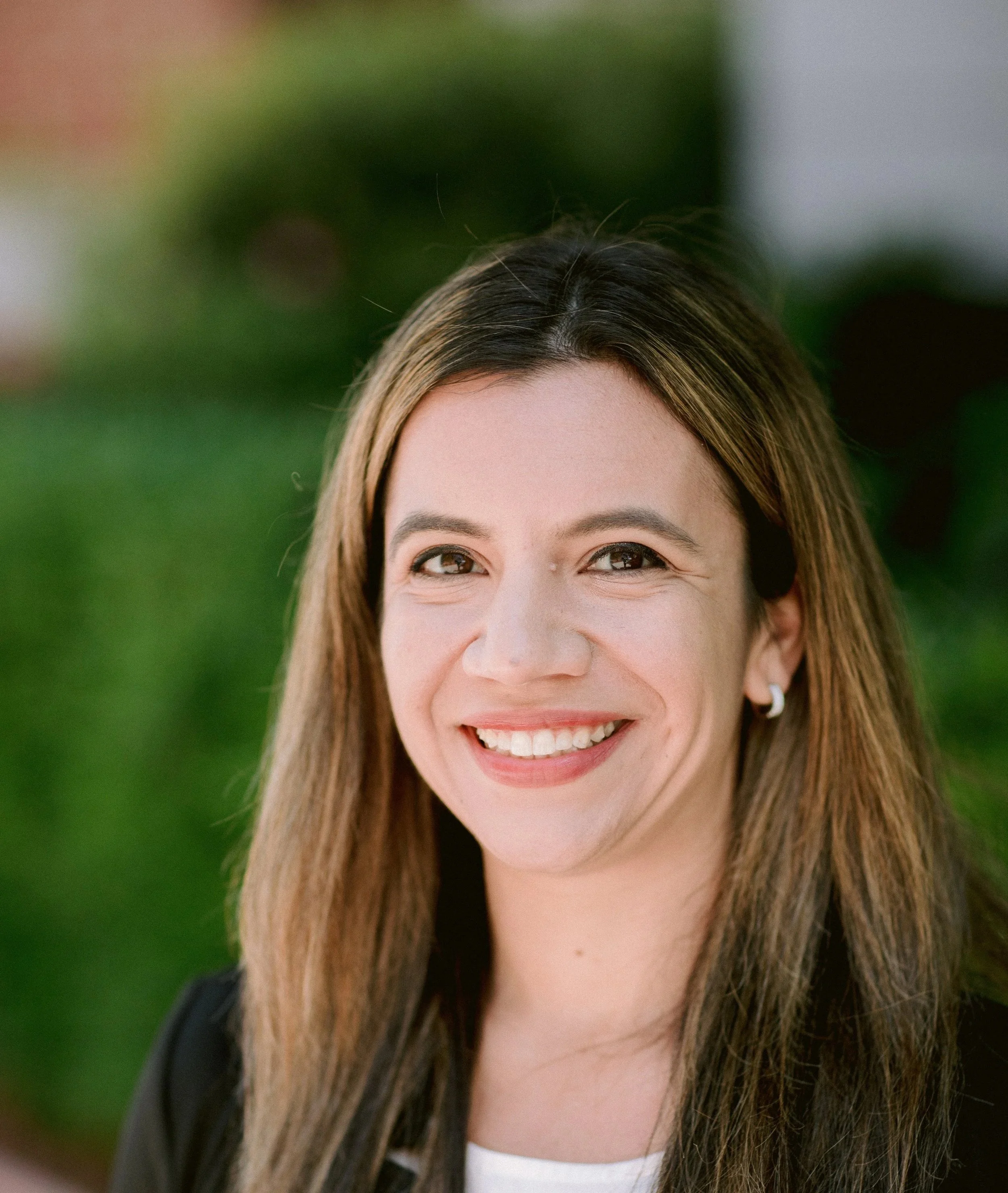 A smiling woman with long brown hair