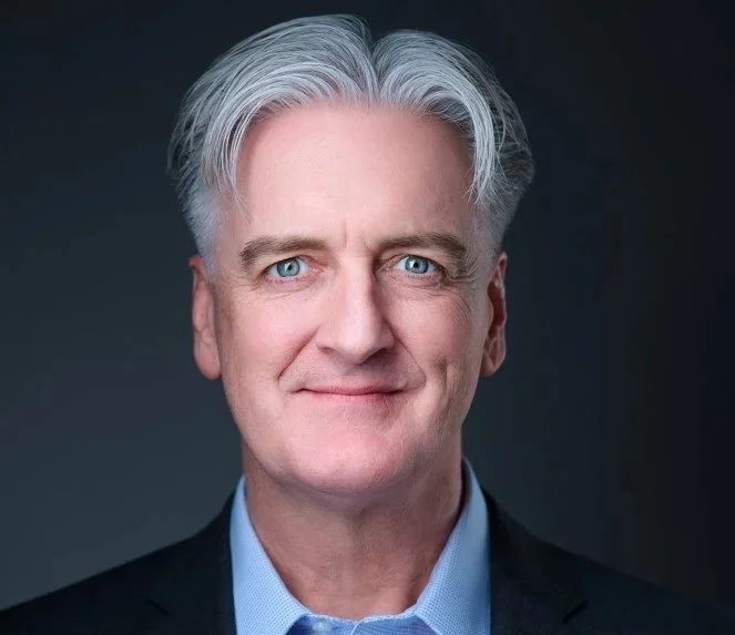 Headshot of a middle-aged man with gray hair