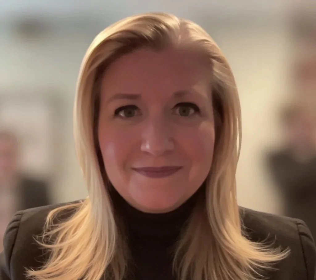 A smiling woman with blonde hair