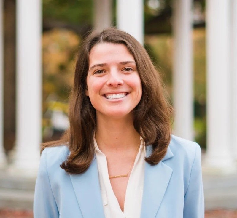 A woman with shoulder-length brown hair, smiling