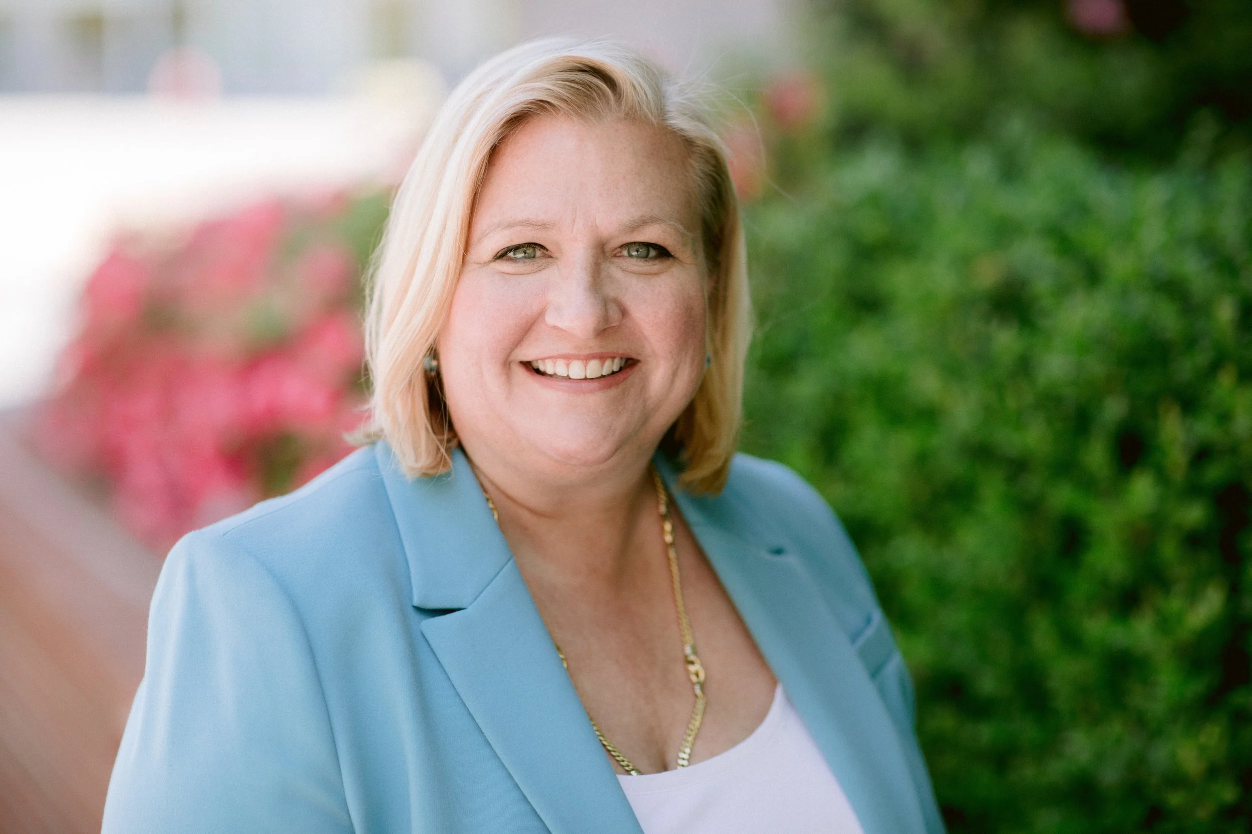 A smiling woman with blonde hair