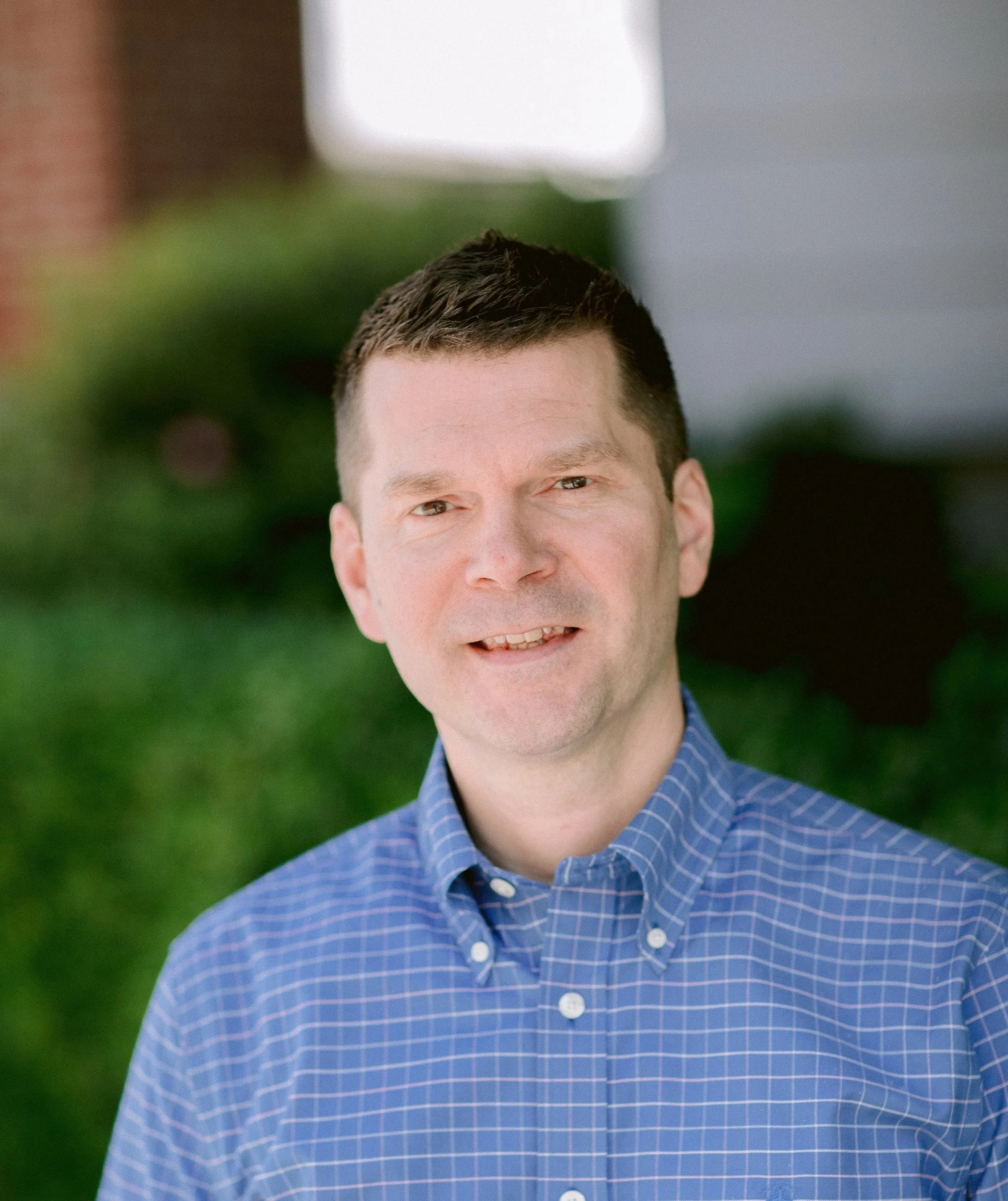 A man with short dark hair and light skin