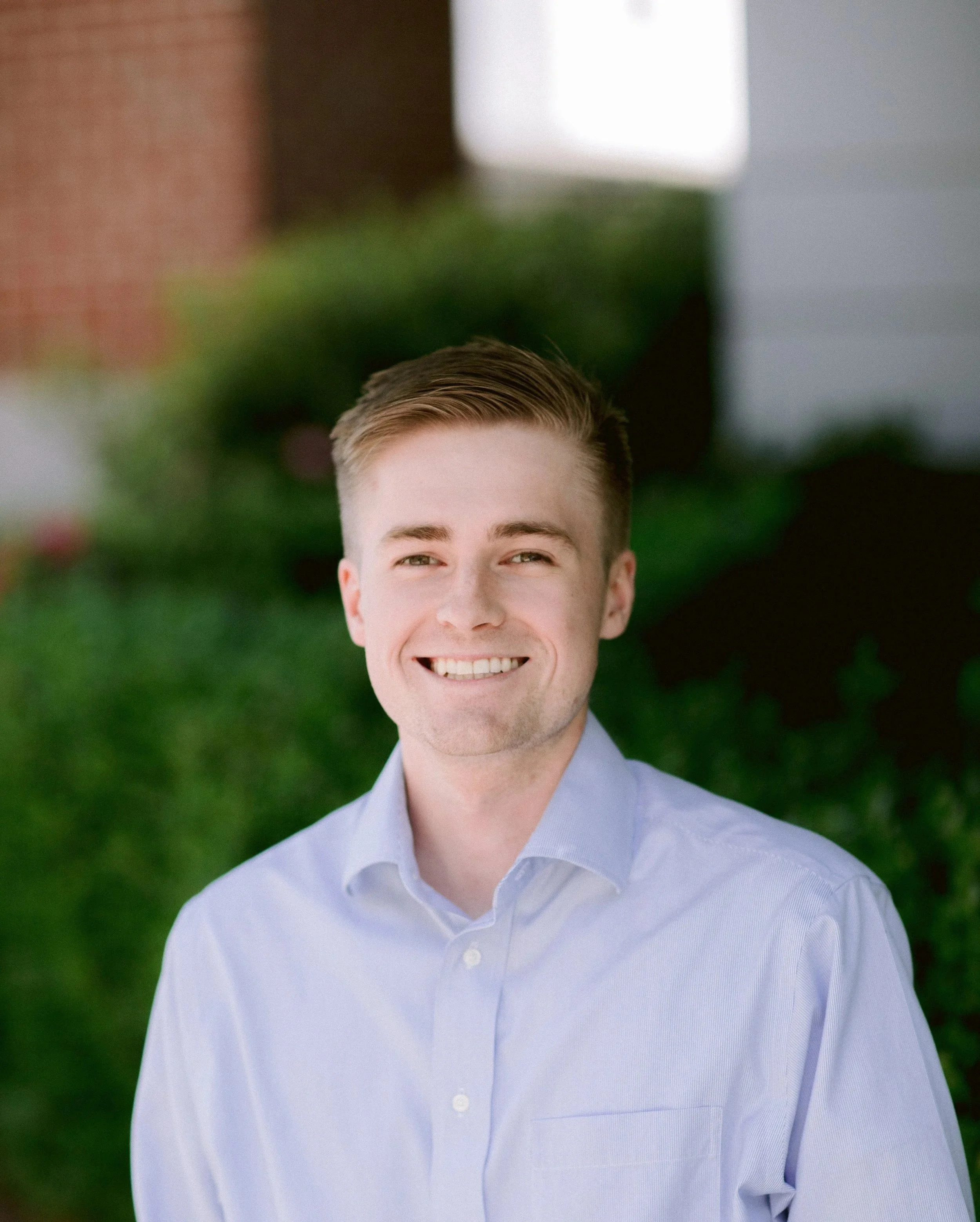 Head and shoulders portrait of a young man with short brown hair
