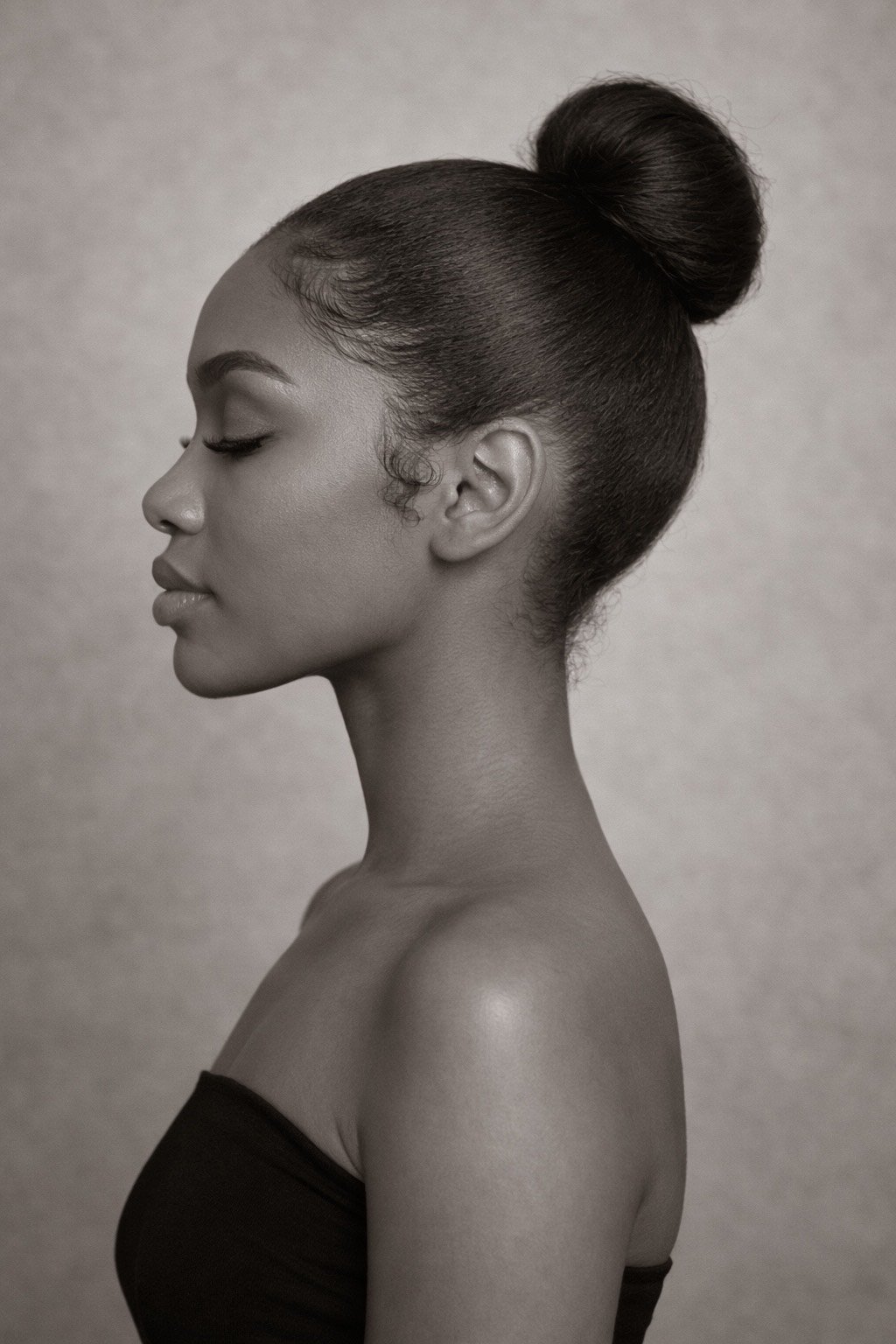 Model with a sleek bun posing for a portrait