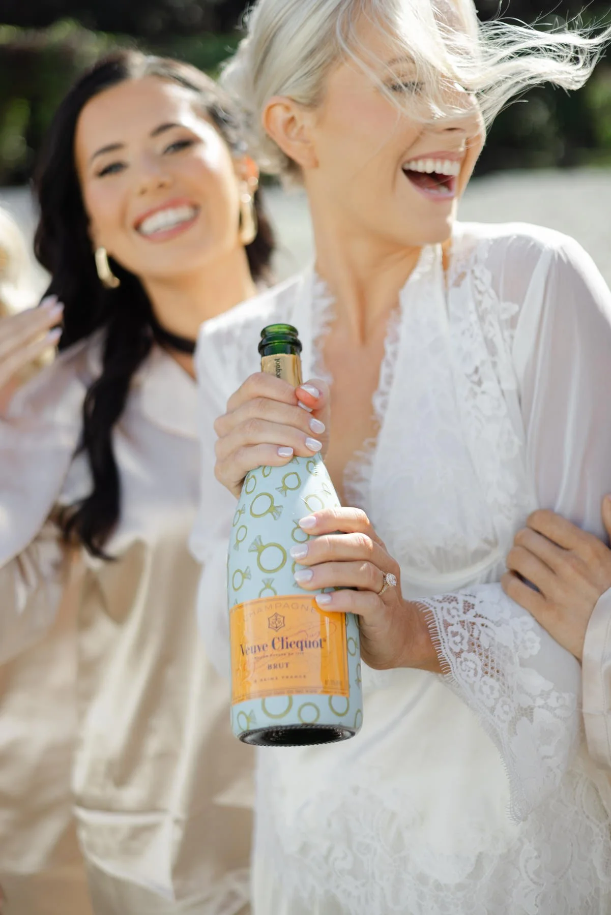 Bride and bridesmaids celebrating with champagne