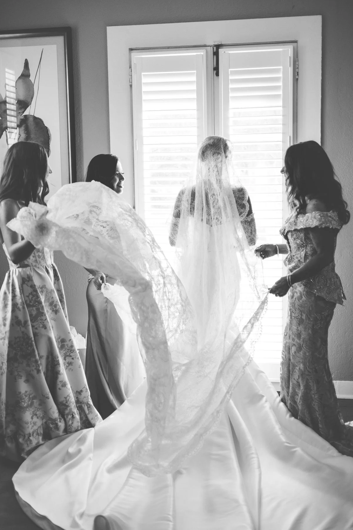 Bride with mother and sisters arranging veil at Jekyll Island