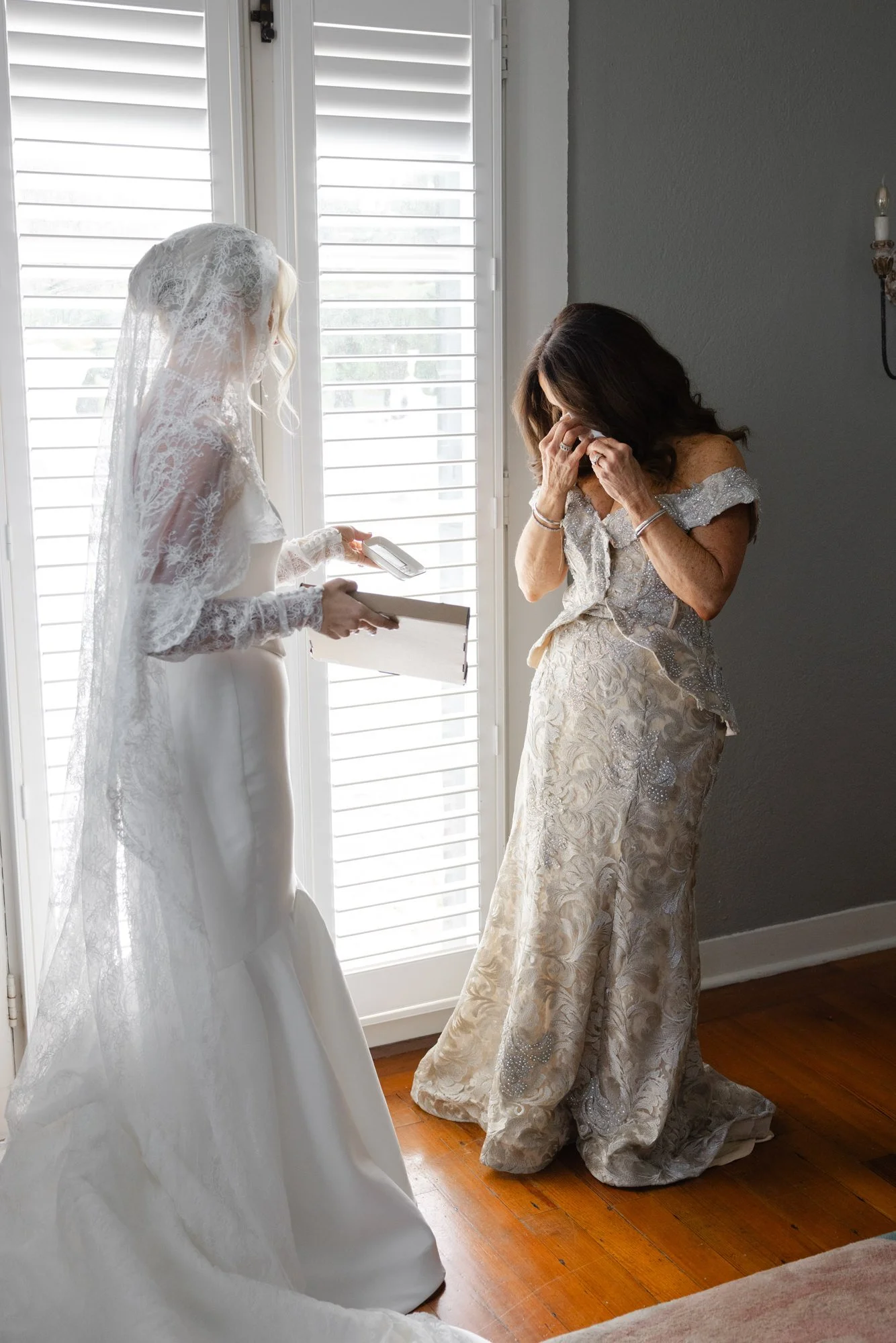 Bride giving her mother a wedding gift