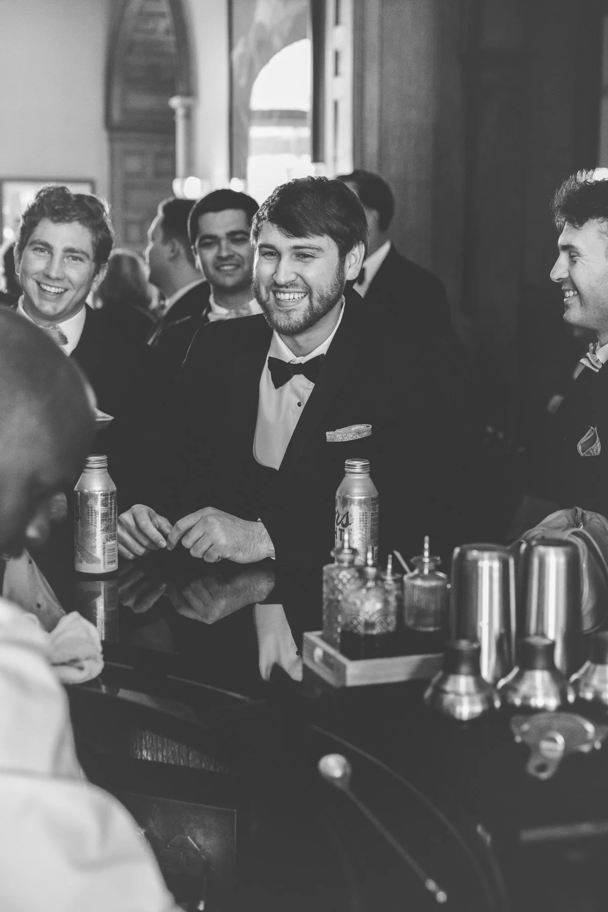Groom hanging out with groomsmen at the bar