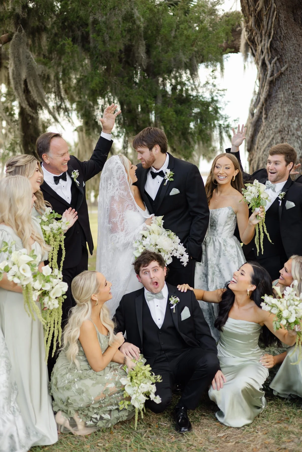Bride and groom with wedding party under live oaks on the Georgia coast