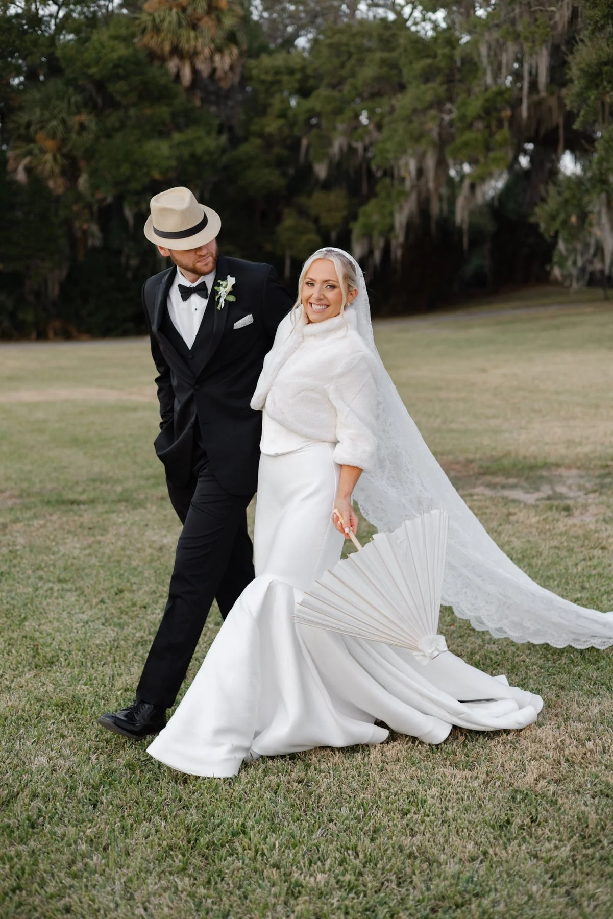 Bride and groom strolling toward the ocean at a Mediterranean luxury wedding