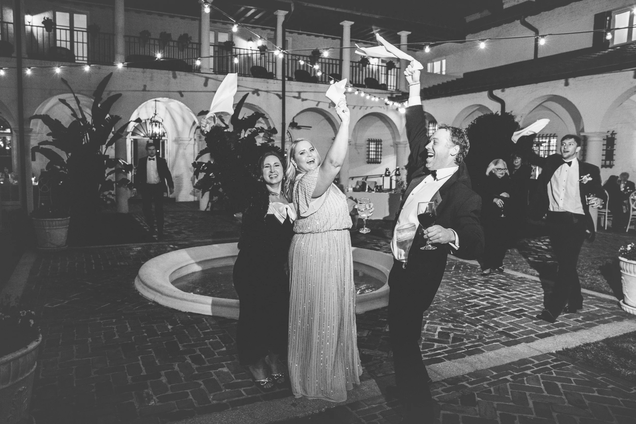Wedding guests celebrating the bride and groom in the courtyard of Crane Cottage on Jekyll Island