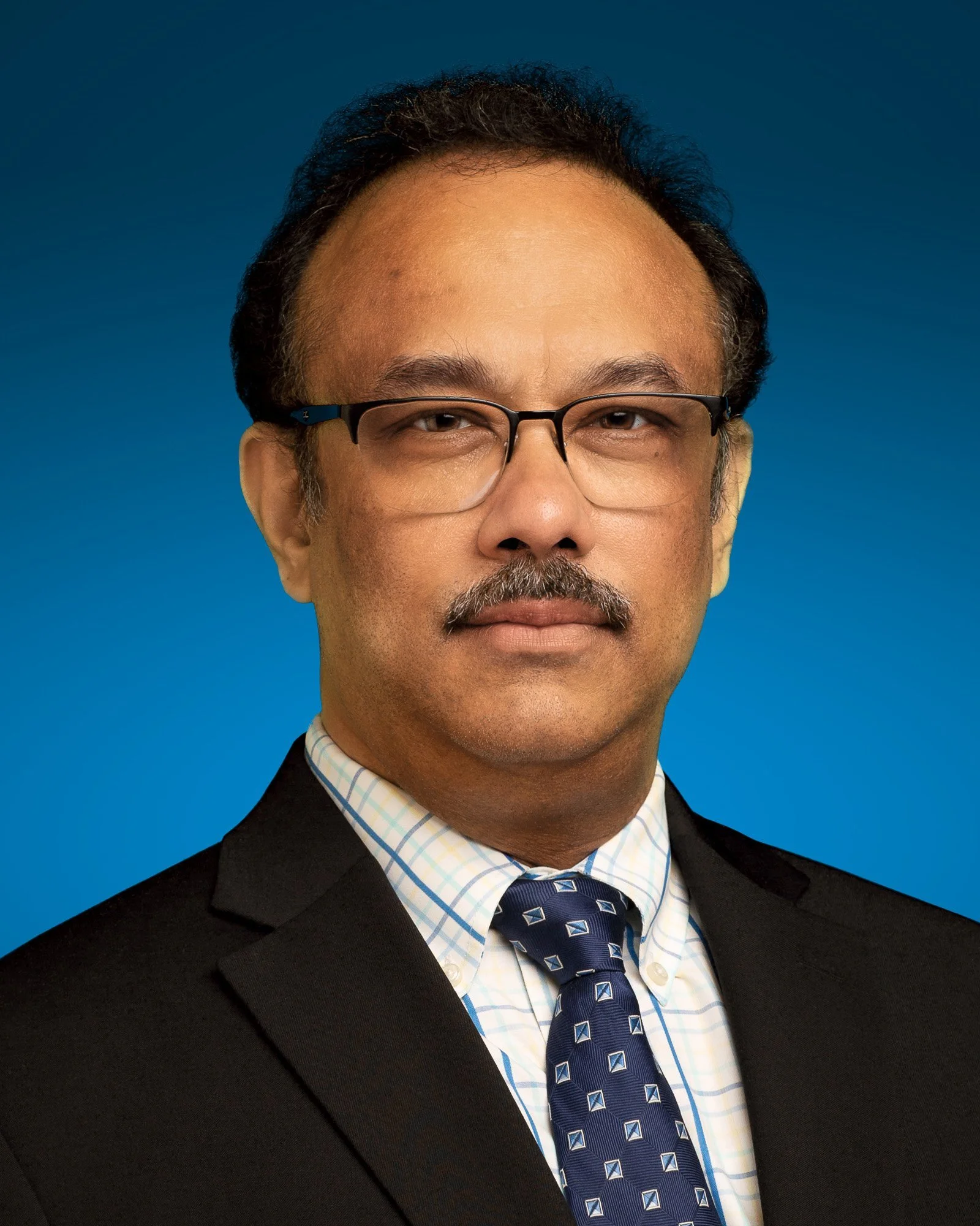 Asian man wearning glasses in a black suit