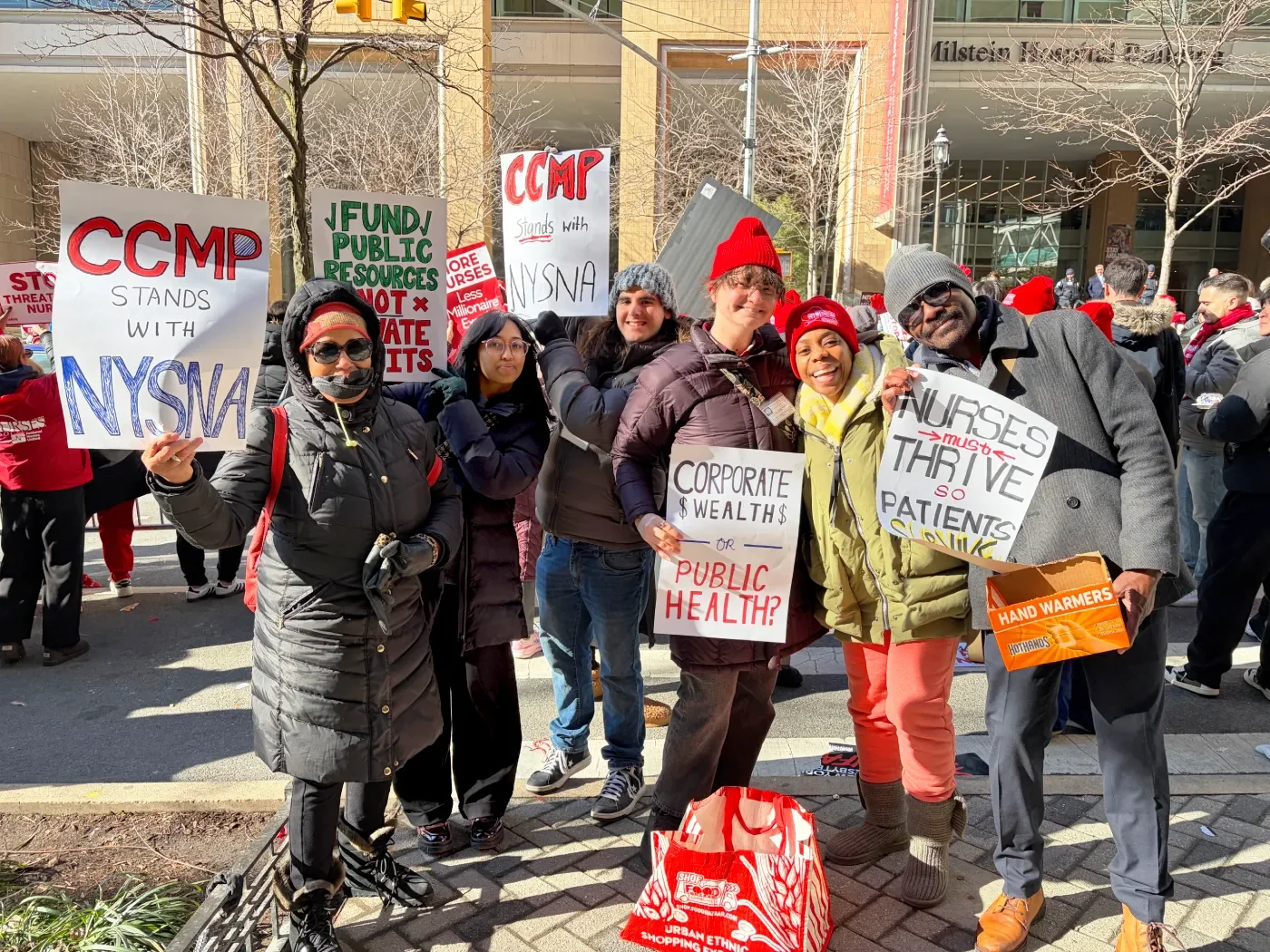 A group of CCMP at a nurses strike on the picket line in solidarity with the nurses. The hats and signs are red.