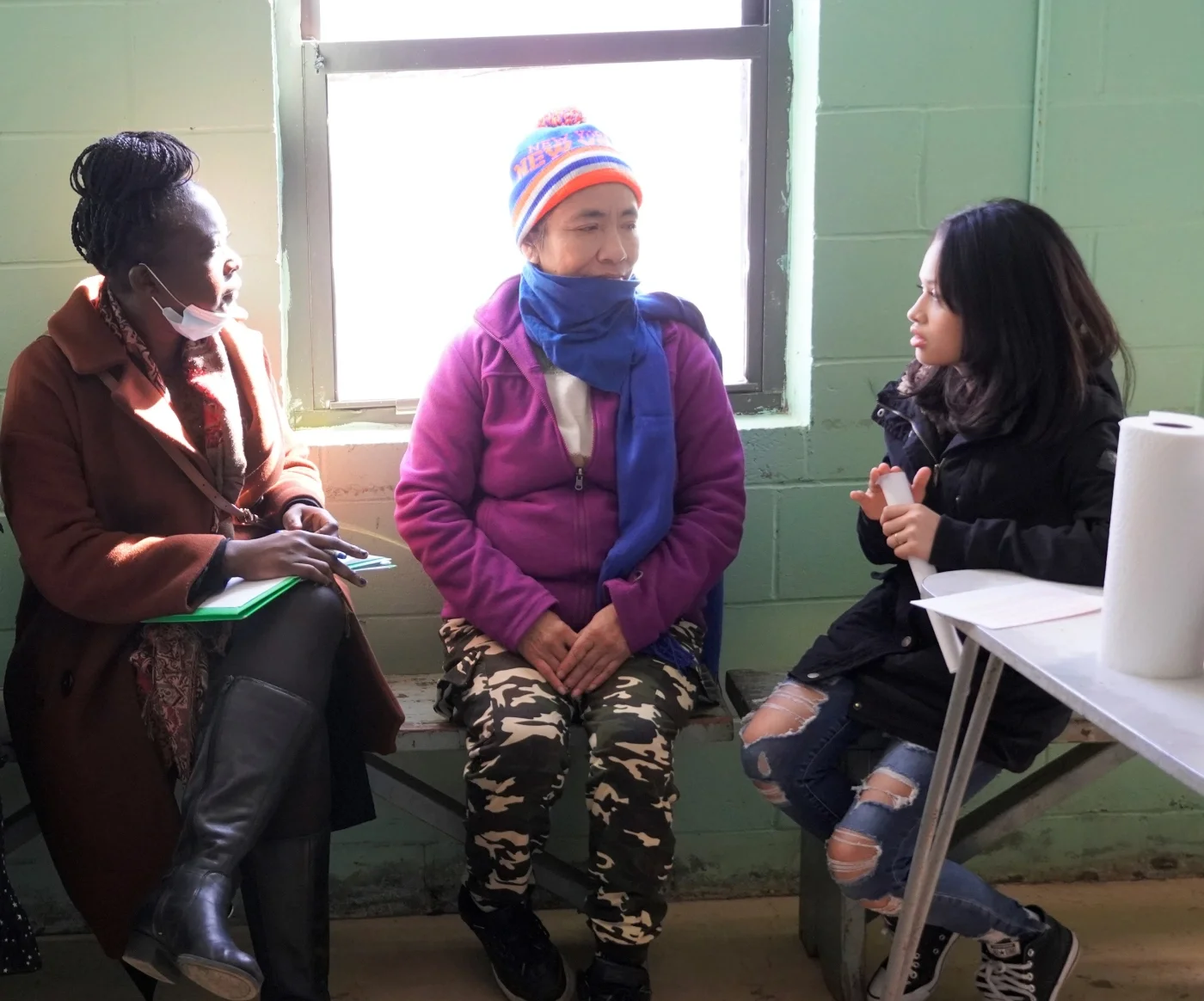 CCMP volunteers at a migrant farm worker camp doing outreach.