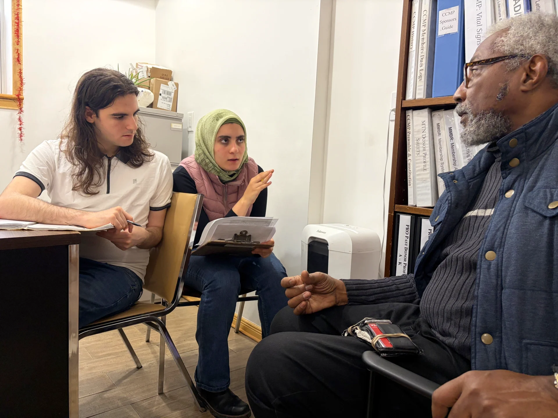 Two CCMP advocates do advocacy for a CCMP benefit recipient. 