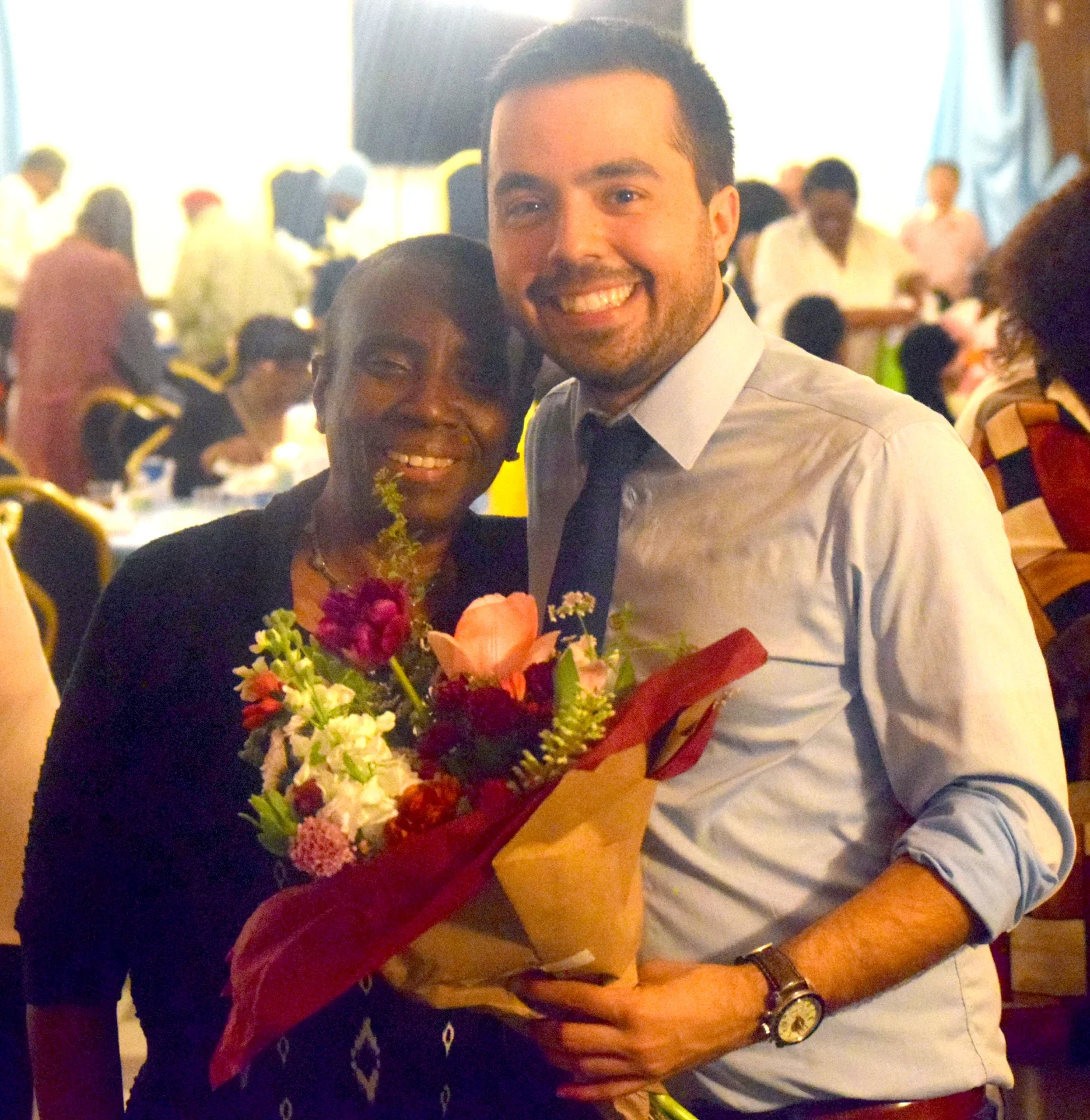 CCMP organizer holding a bouquet of flowers with a CCMP volunteer.