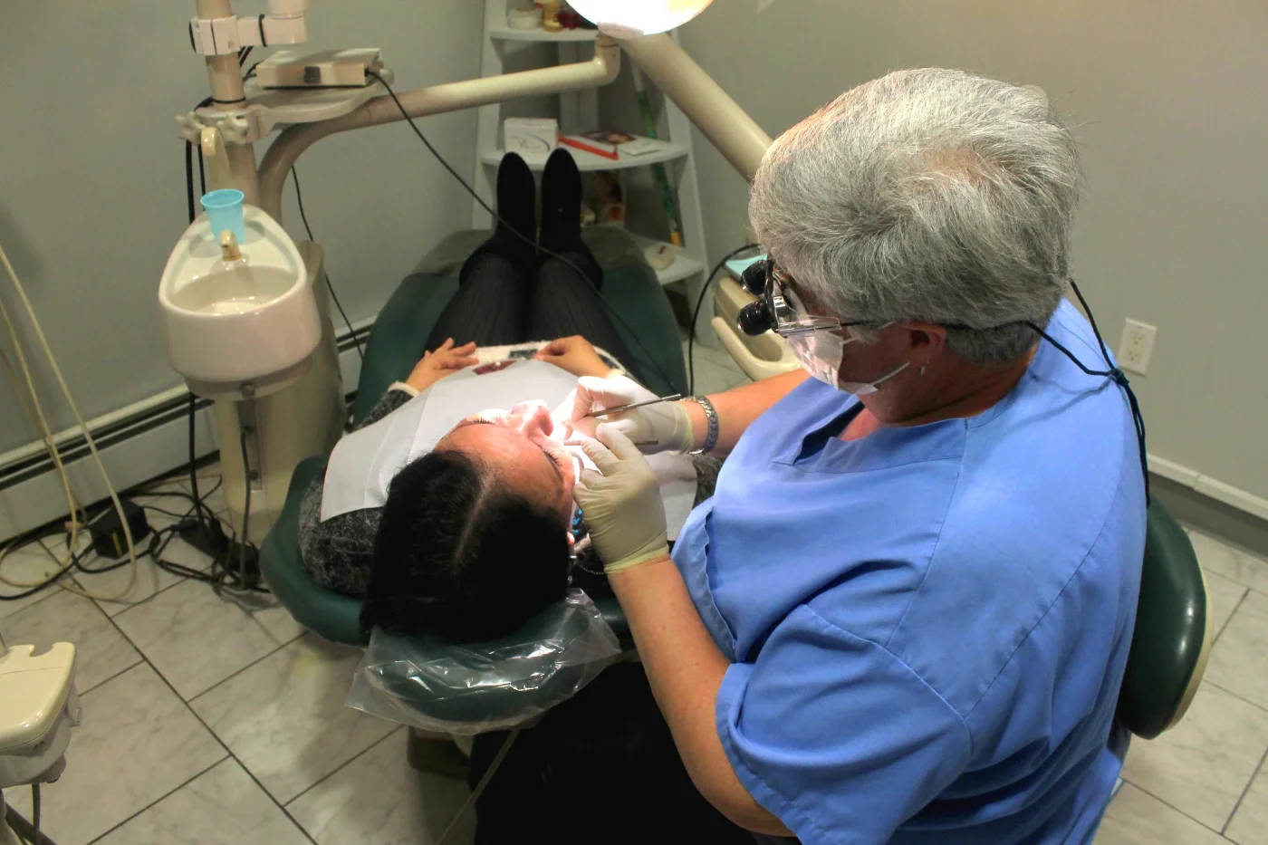 A volunteer dentist providing a dental procedure to a patient.