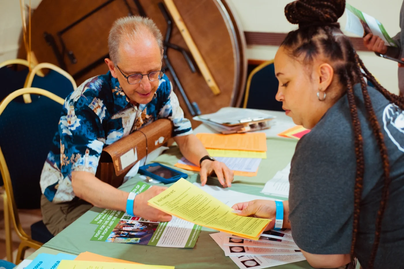 A volunteer doctor reviewing an informational flyer with a benefit recipient.