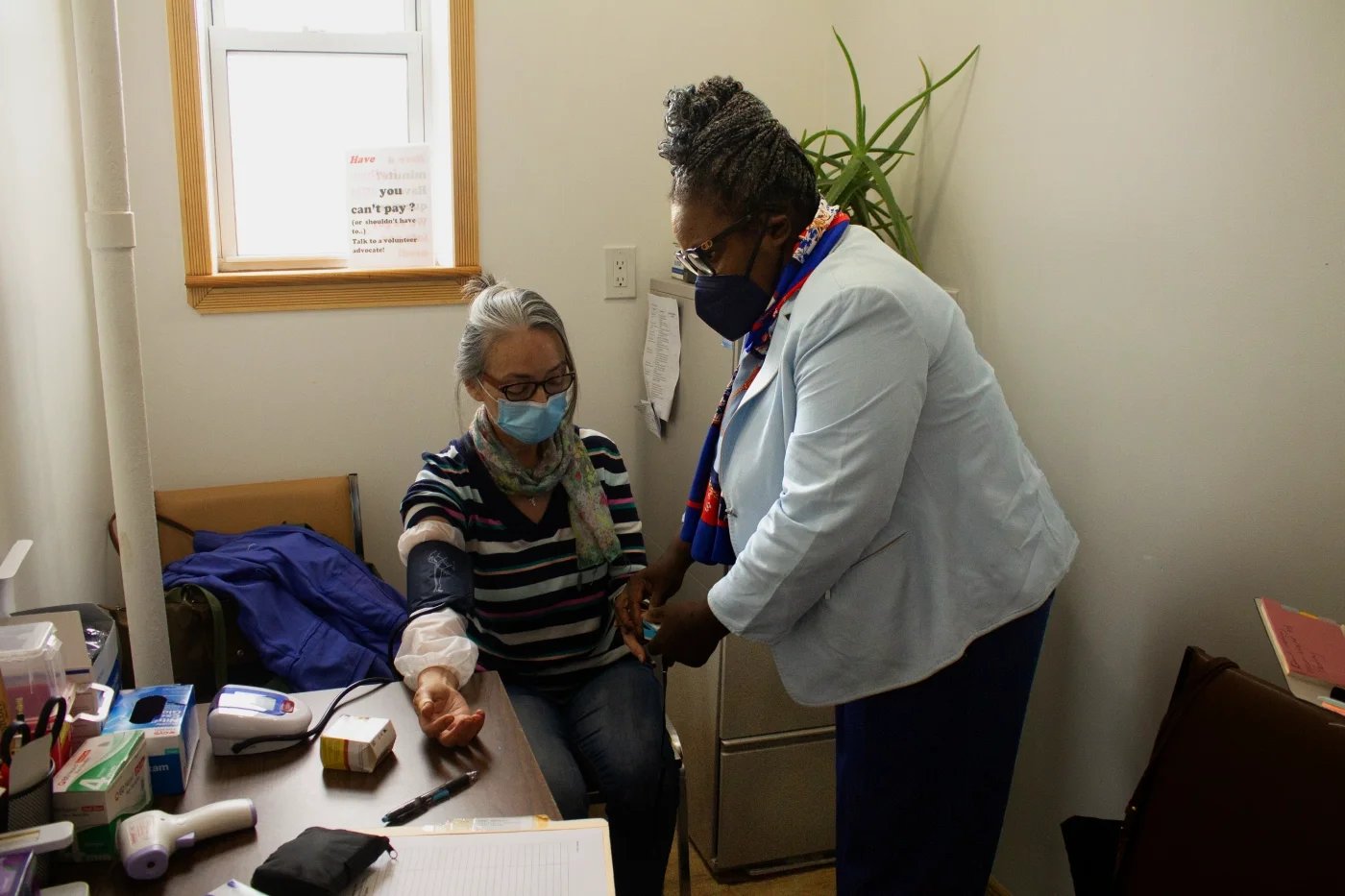 A volunteer doctor checking vitals.