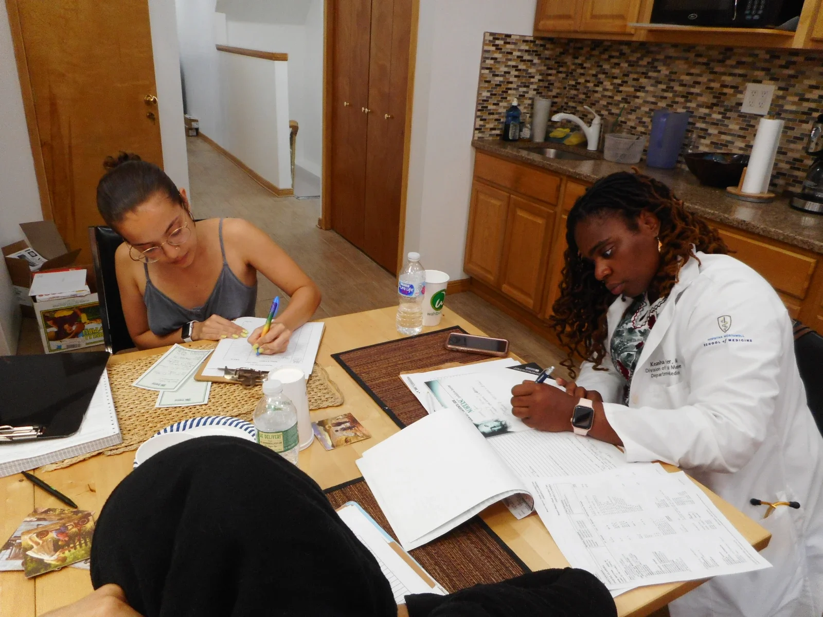 CCMP medical professionals and volunteers update records after a CCMP medical session.