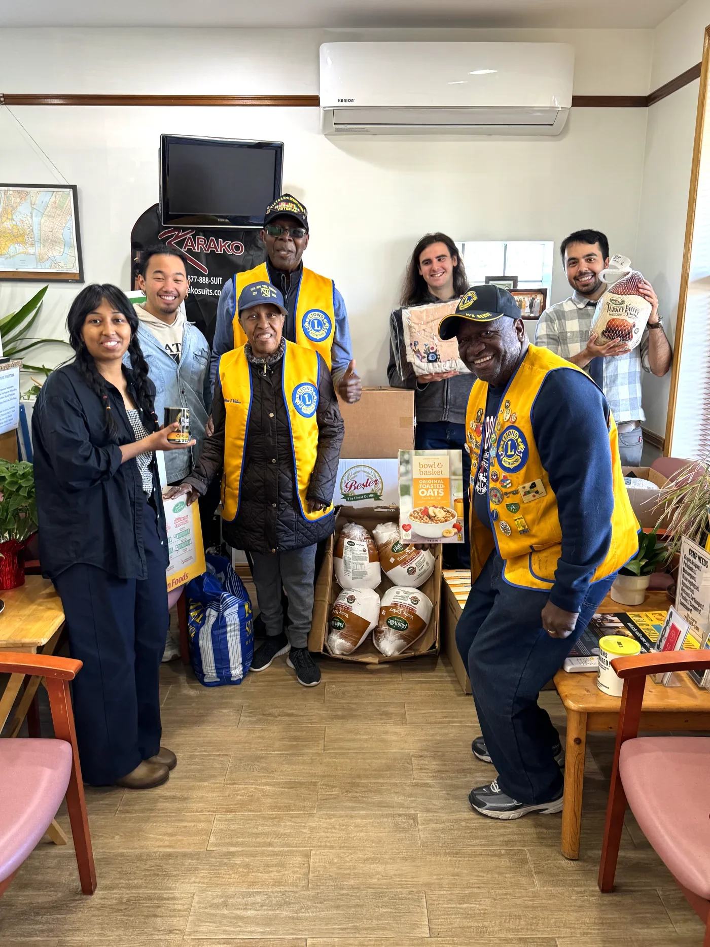 A group of from a local Lions Club posing with CCMP volunteer while dropping off food to the CCMP office as a donation.