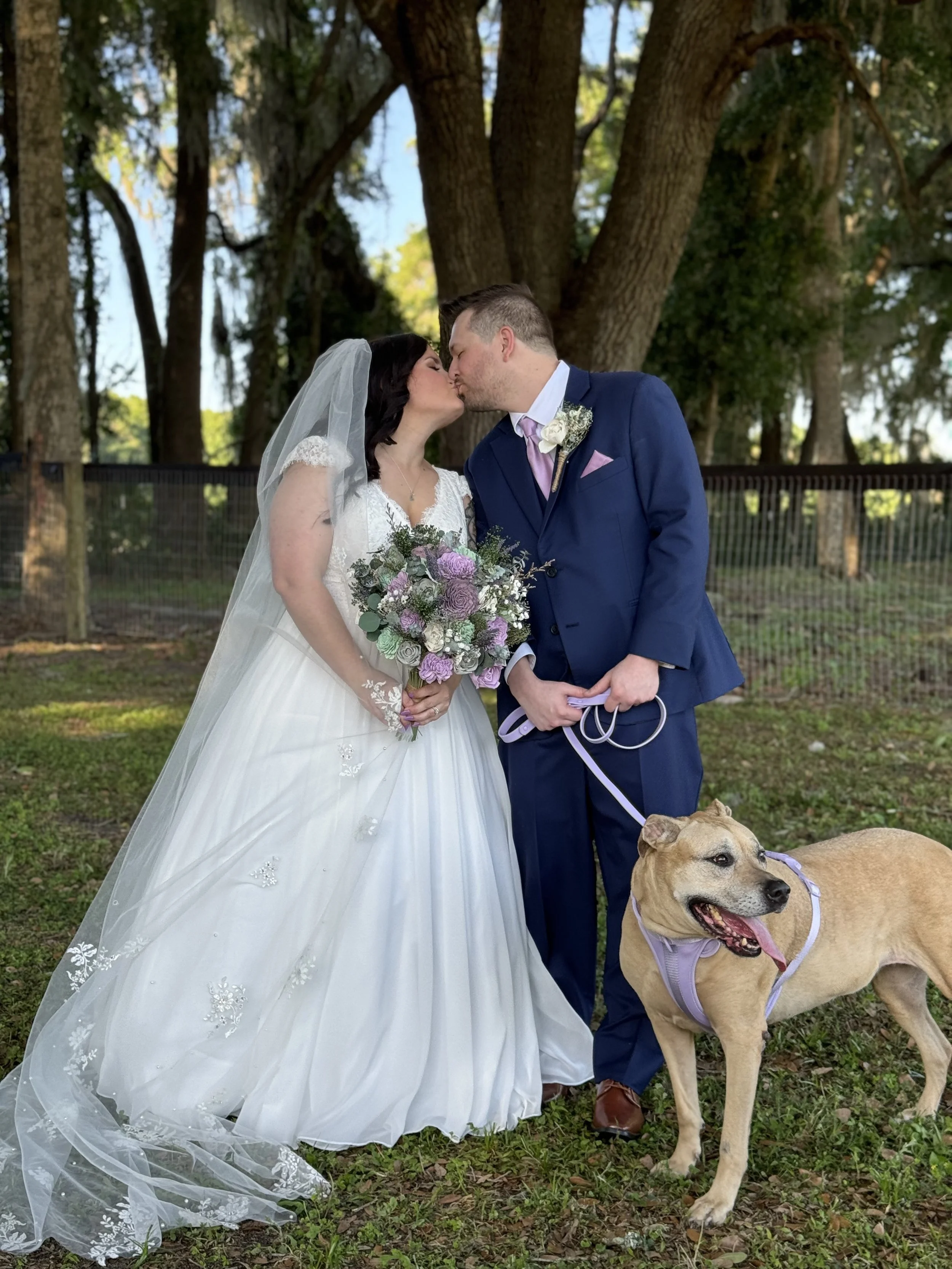 kissing couple with dog 