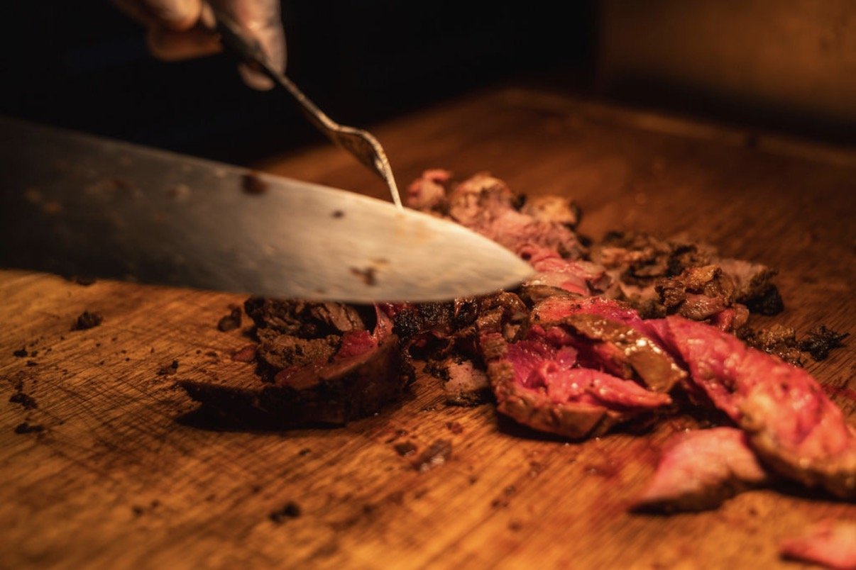 steak being cut with a knife 