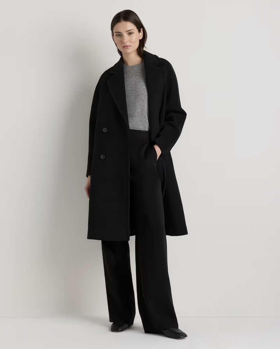 A woman wears a Quince Wool Cashmere Slouch Coat as an alternative to the quiet luxury of the Max Mara Madame Wood and Cashmere Coat