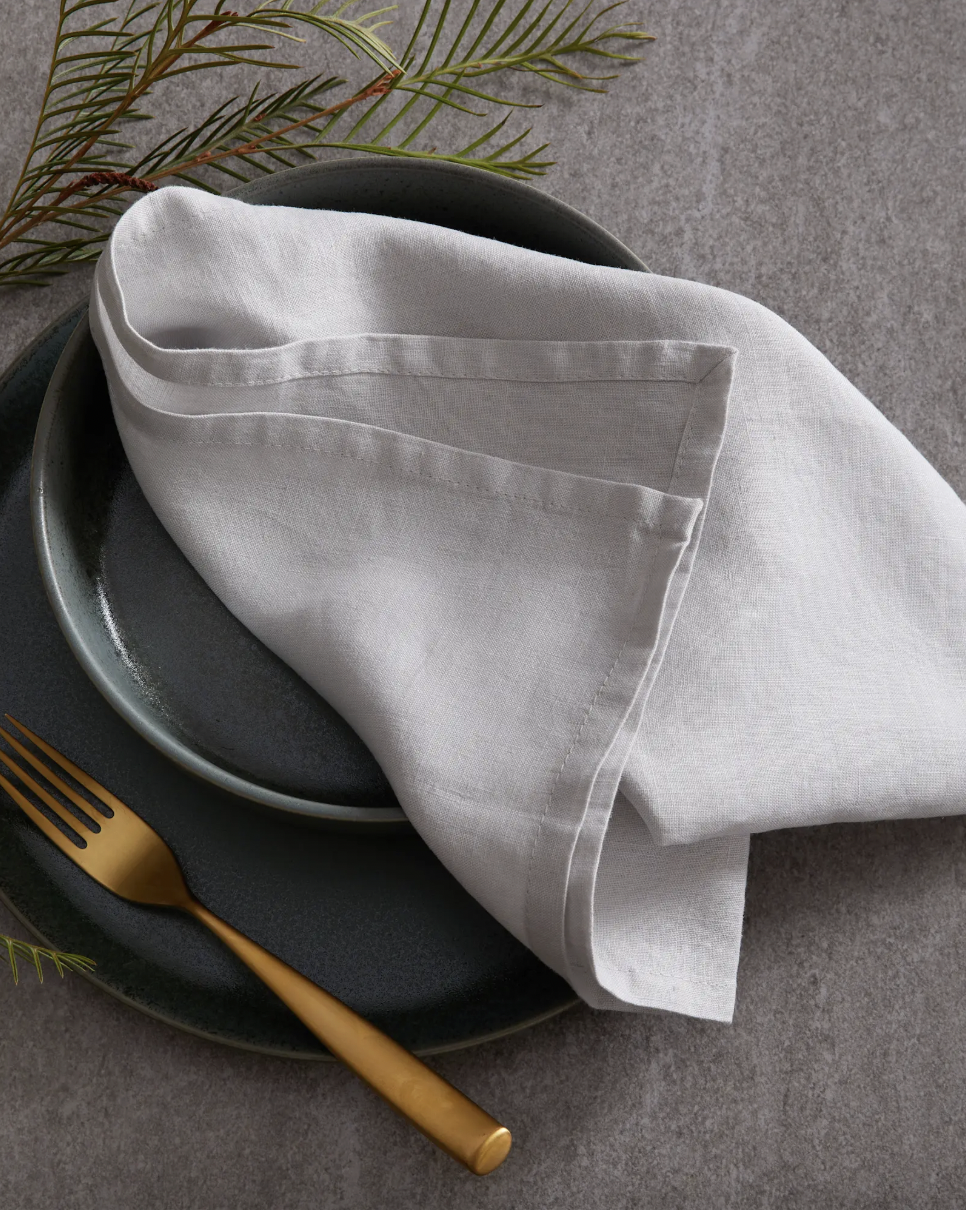 Quince European Linen Napkin on a gray ceramic plate