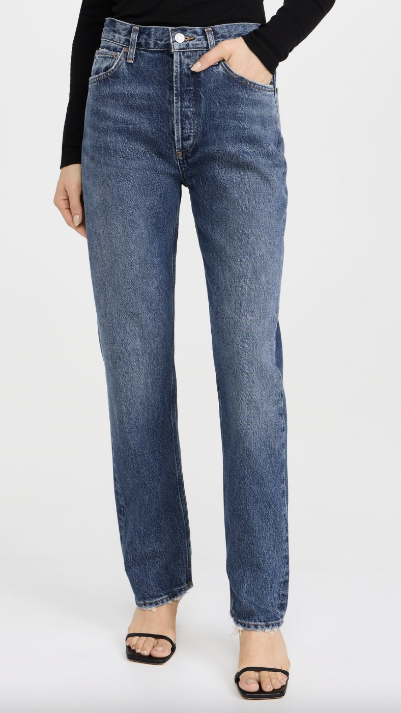 A model wearing Agolde 90s Pinch Waist: High Rise Straight Jeans with black sandals
