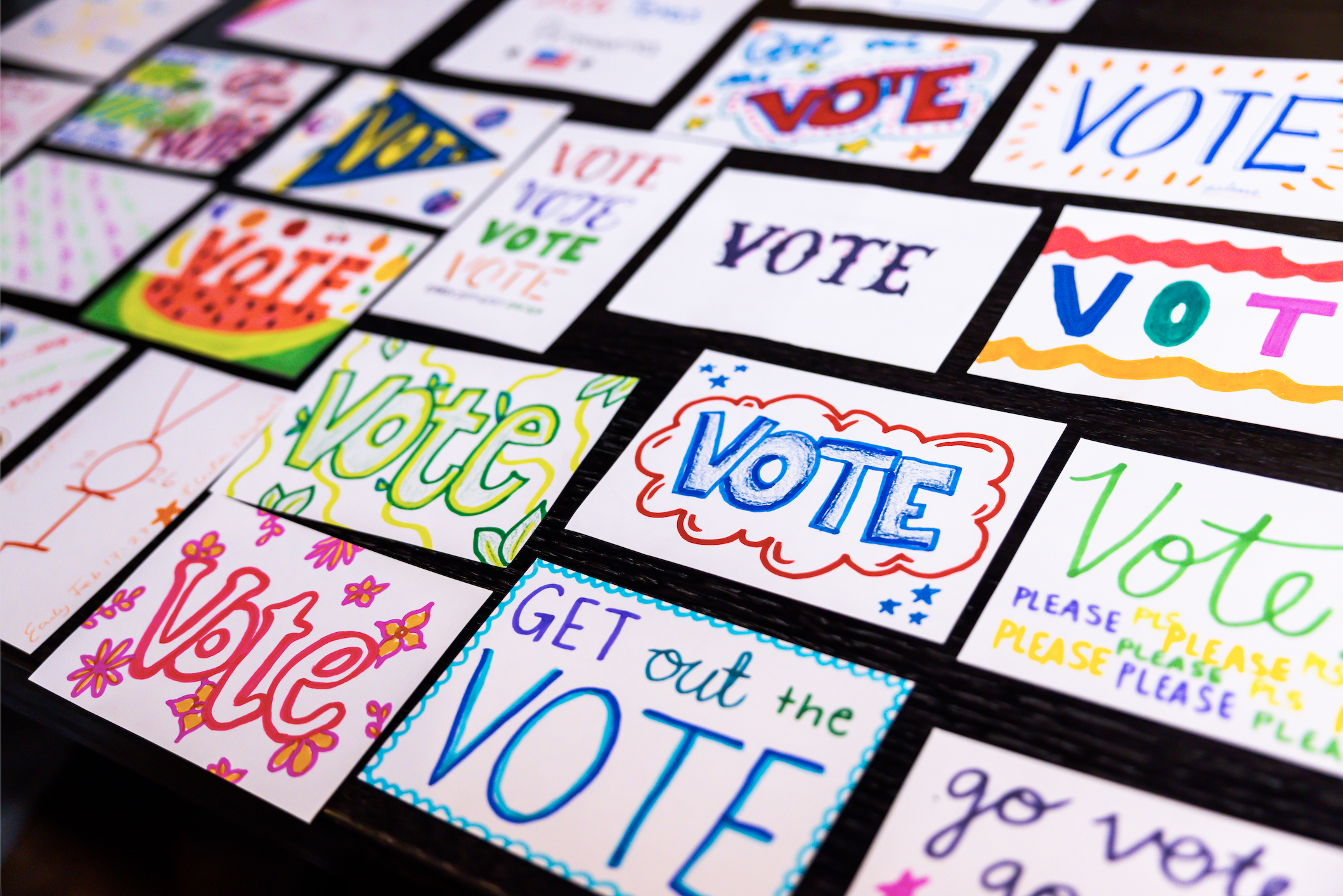 Over 22 index cards with colorful designs and text. Some read "Vote" and "Get out the vote"