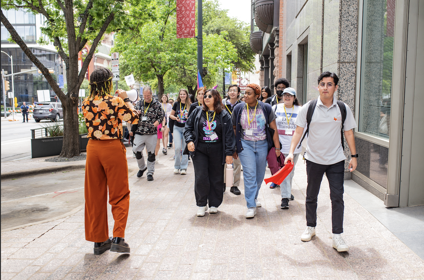 Student with a megaphone gathers people during a march during the Youth Capitol Takeover 2023