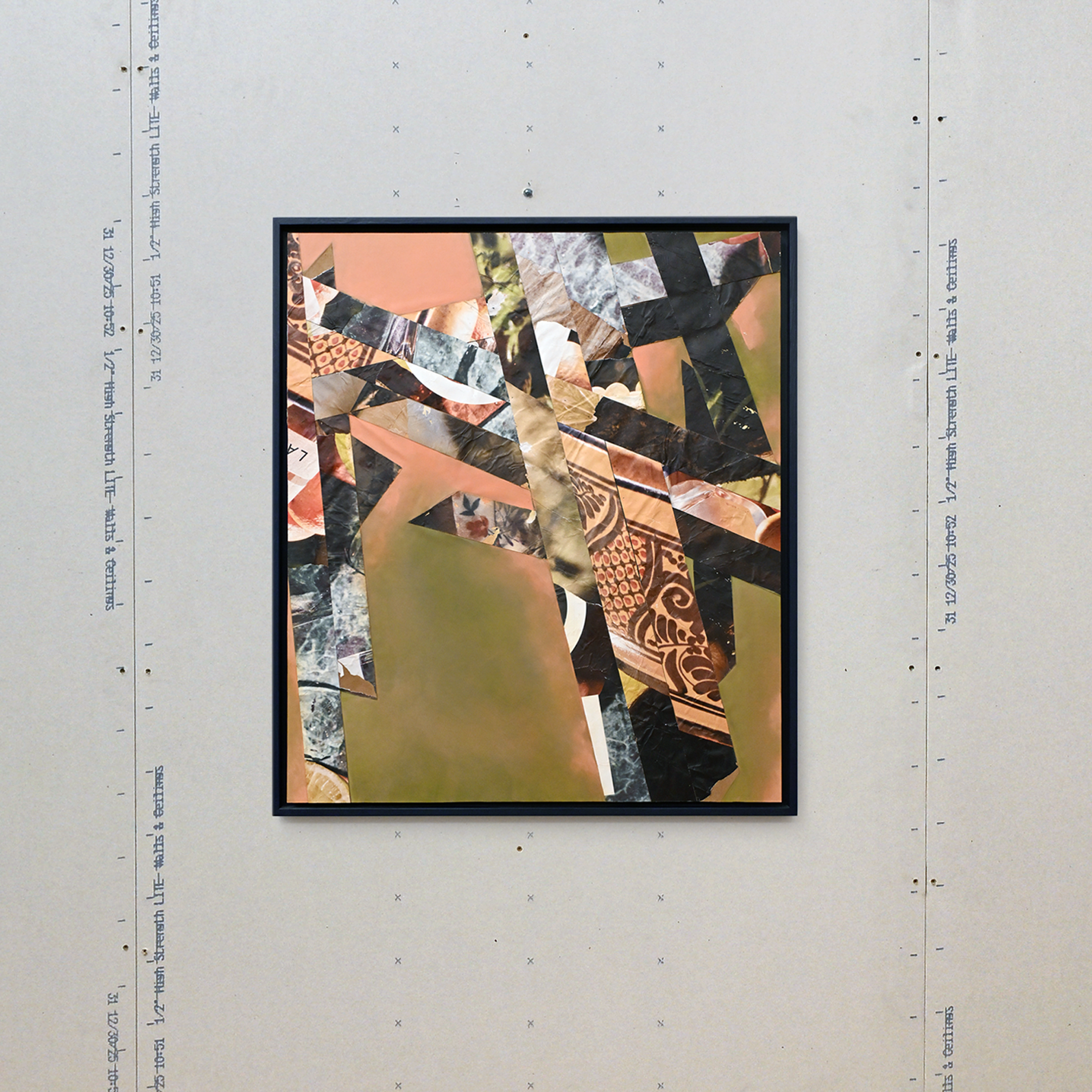 Abstract collage artwork featuring ochre green warm hues juxtaposed against geometric shapes and patterns mounted and framed in a floating dark blue frame