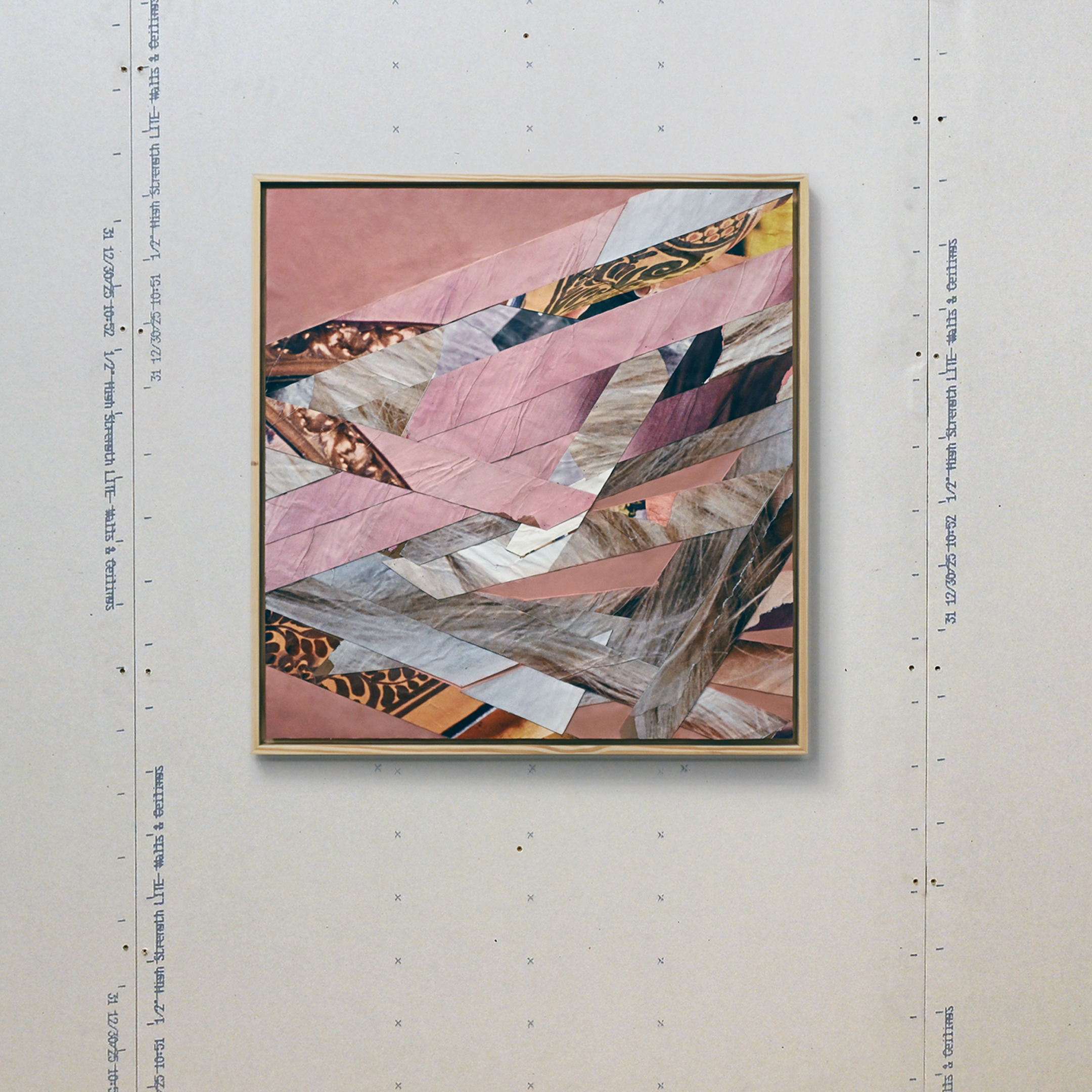 Abstract pink colored collage of various patterned and textured paper arranged in geometric shapes within a wooden frame