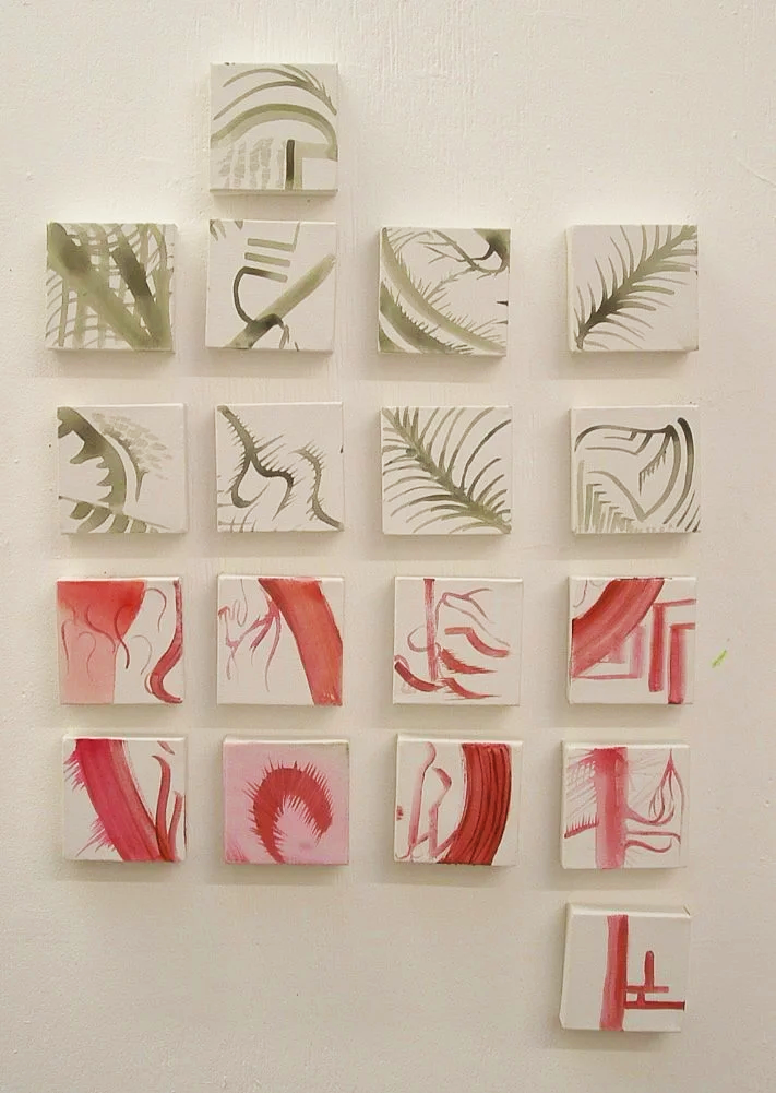 A wall display of 15 small canvas paintings arranged in a rectangular grid, alternating between black-and-white botanical designs and abstract red brushstrokes.