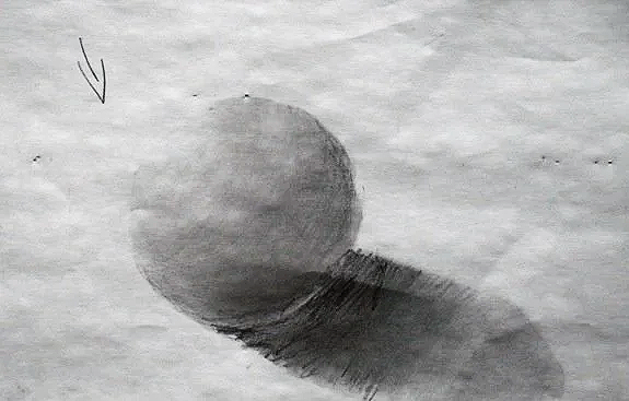 Pencil drawing of a shaded sphere casting a shadow on paper.