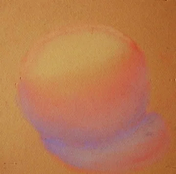 Soft pastel-colored round object with a blend of pink, purple, and yellow hues.
