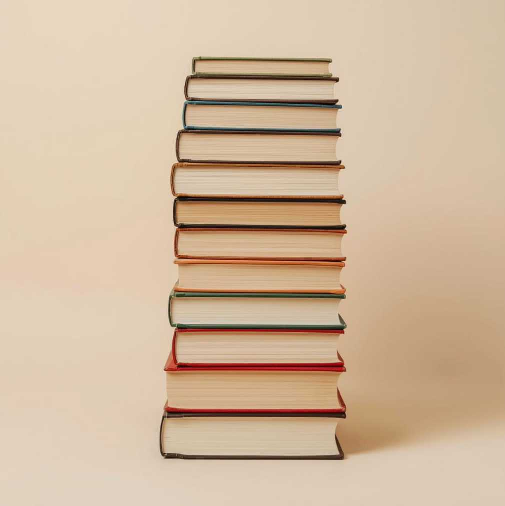 A tall stack of hardcover books against a beige background.